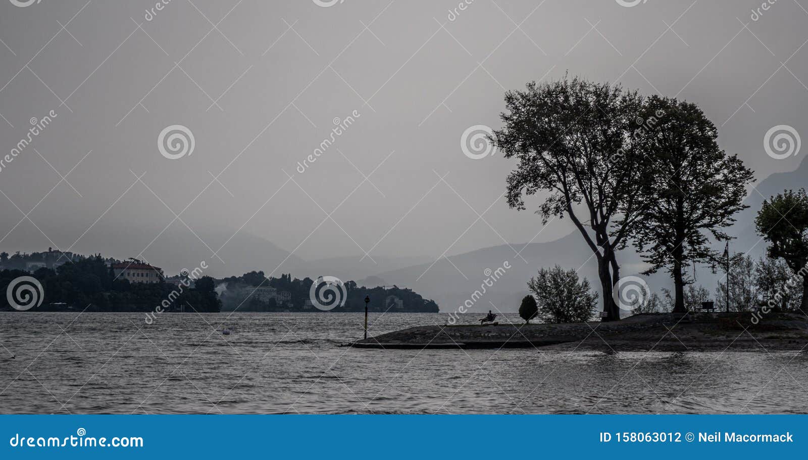 a grey misty morning on the lake maggiori in italy. stock