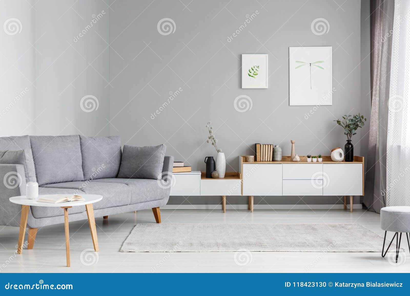 grey settee near white cupboard in minimal living room interior