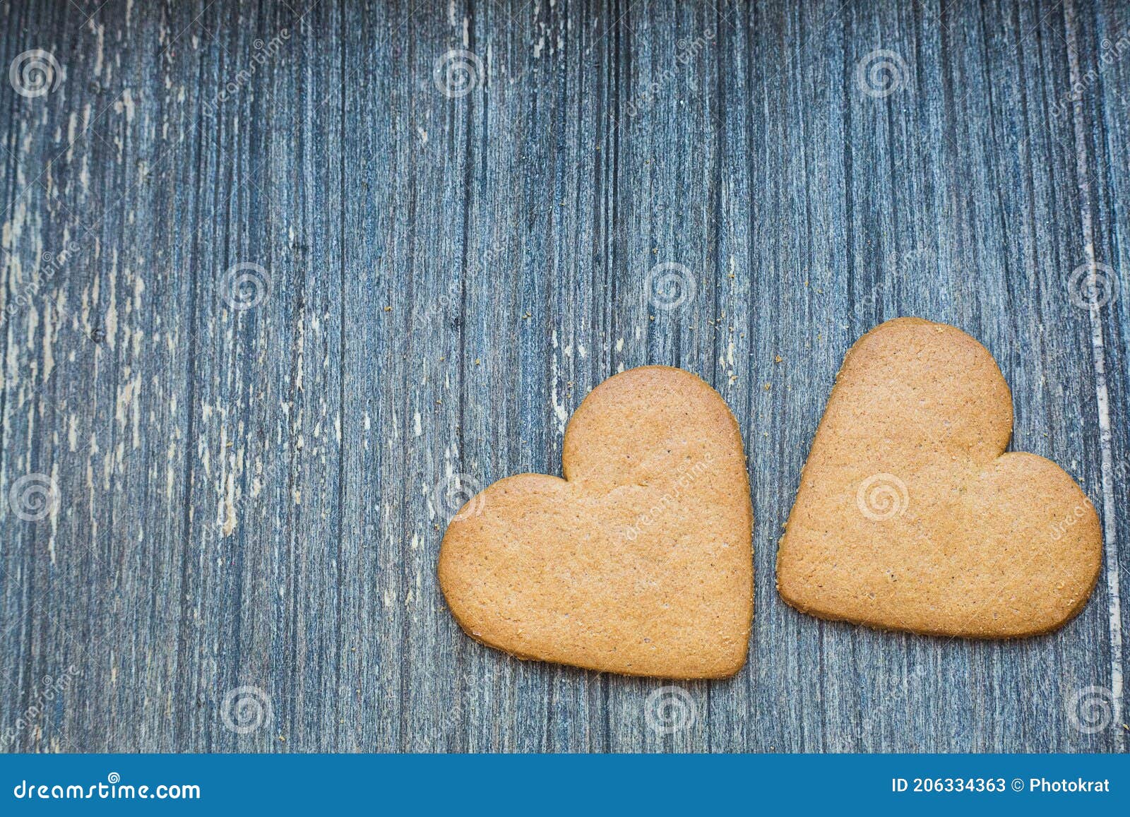 grey wooden aged background with ginger bread biscuits. saint valentines frame with copy space. love and wedding