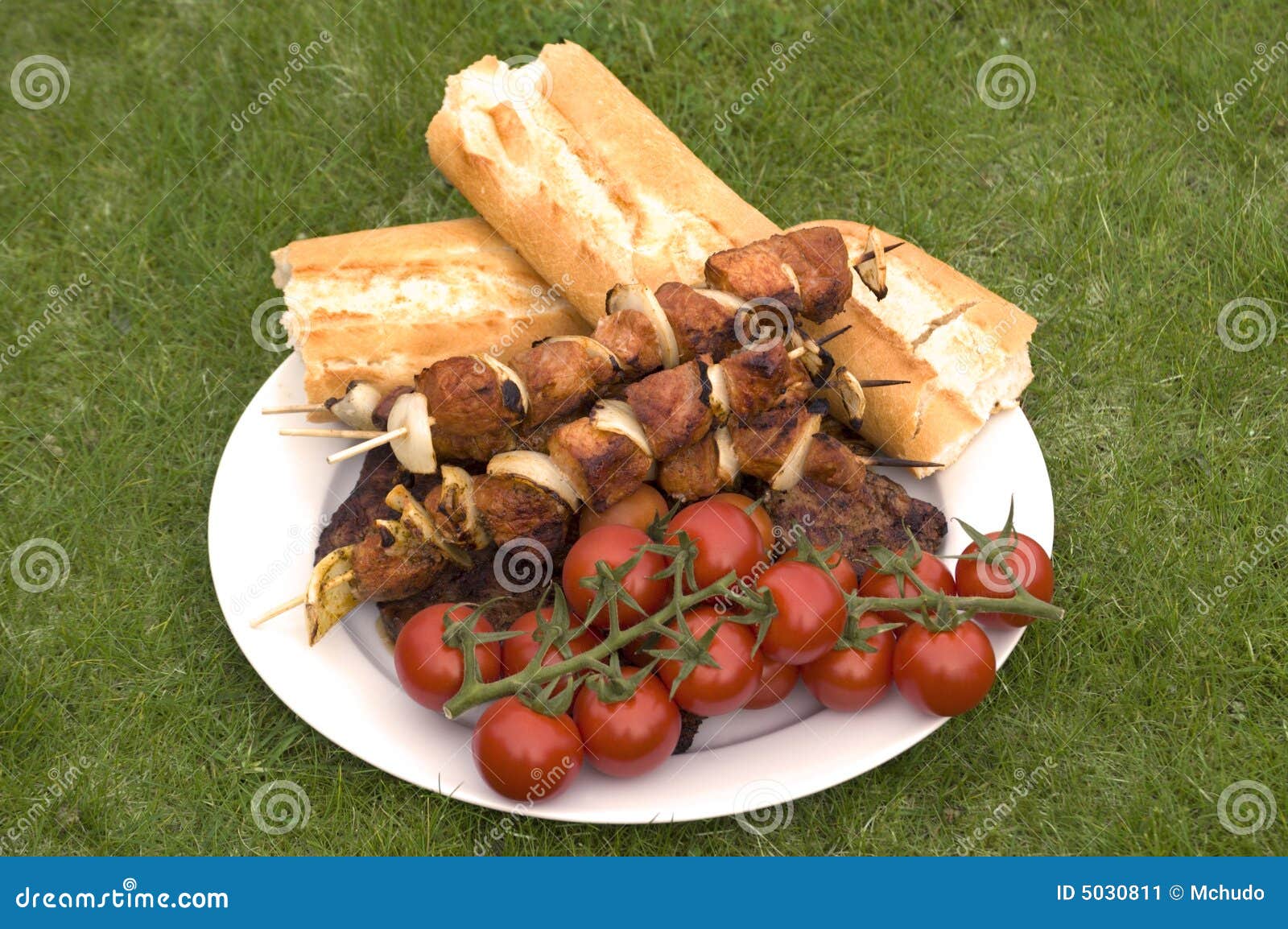 Grilled barbecue meat and bread and tomatoes