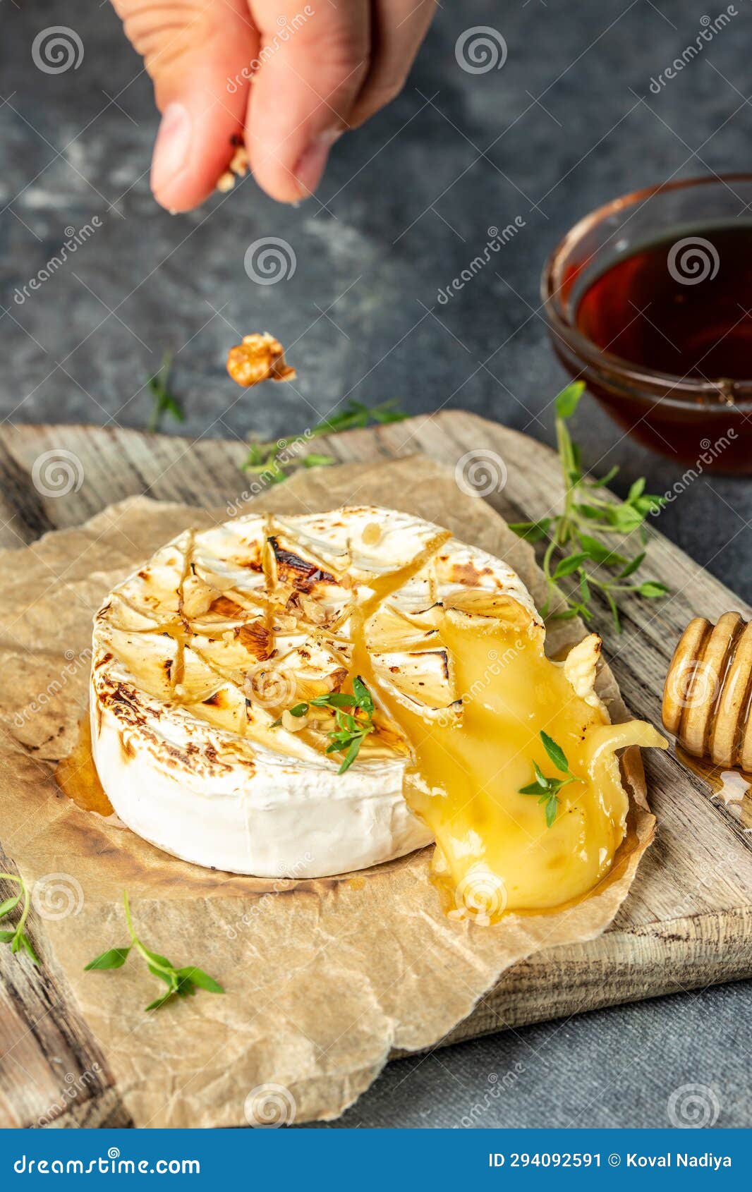Grilled Camembert Cheese with Walnuts and Honey. Vertical Image. Top