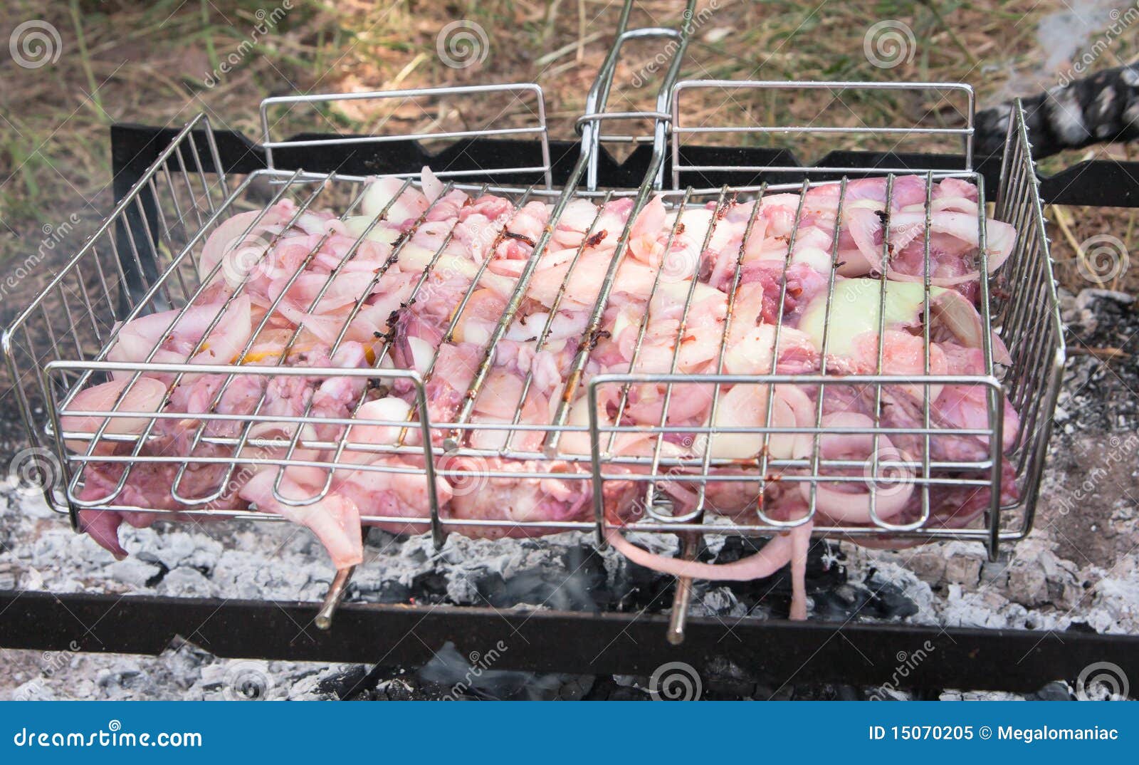 Grilled chicken barbeque cooking over charcoal