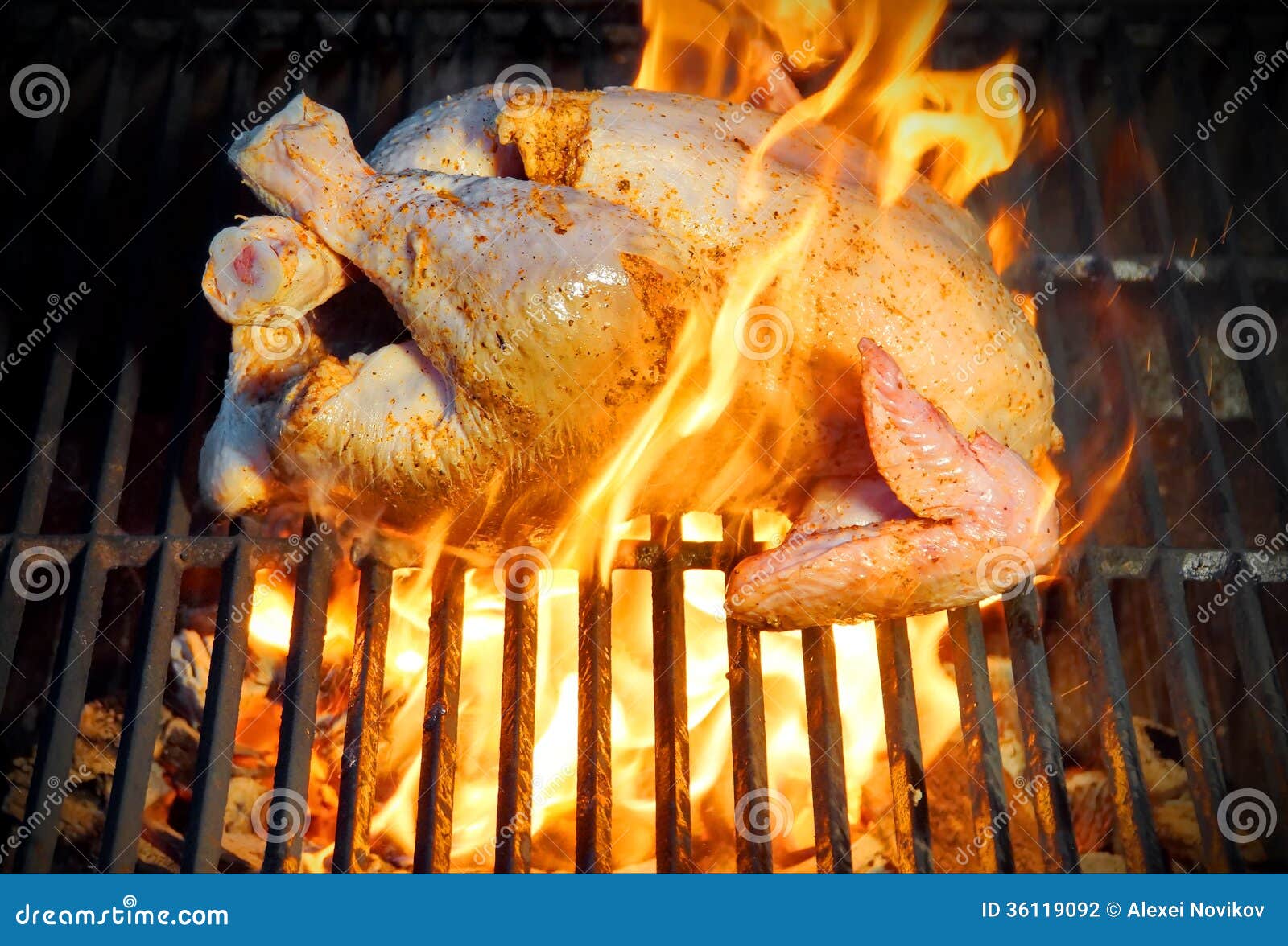 Grilled chicken in flames stock photo. Image of dinning 36119092