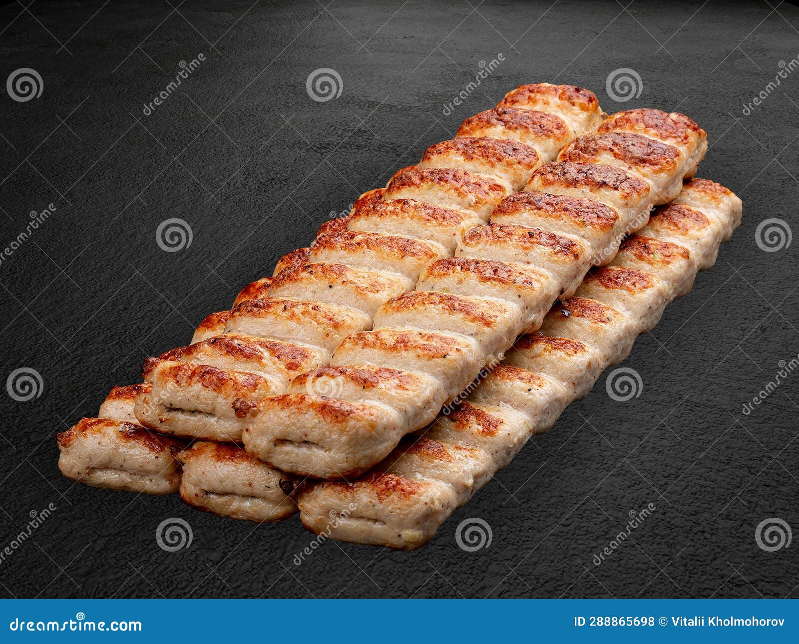 grilled chicken lulas. ground meat product. grill menu.  on a dark background