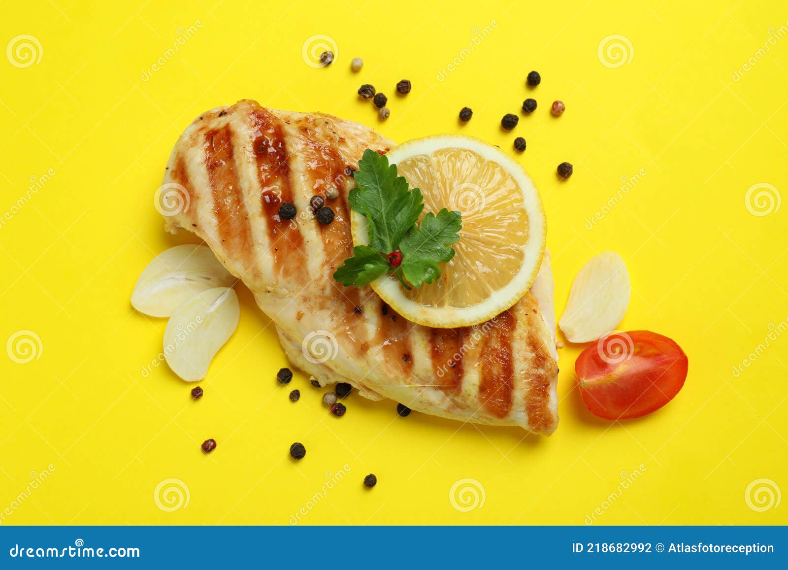 Grilled Chicken Meat and Ingredients on Yellow Background Stock Photo
