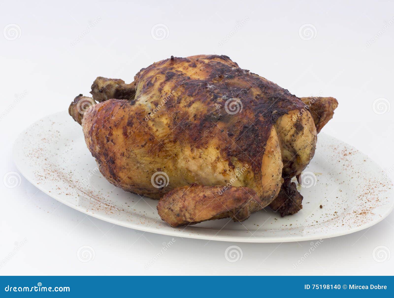 grilled chicken (pollo a la brasa) on white plate.