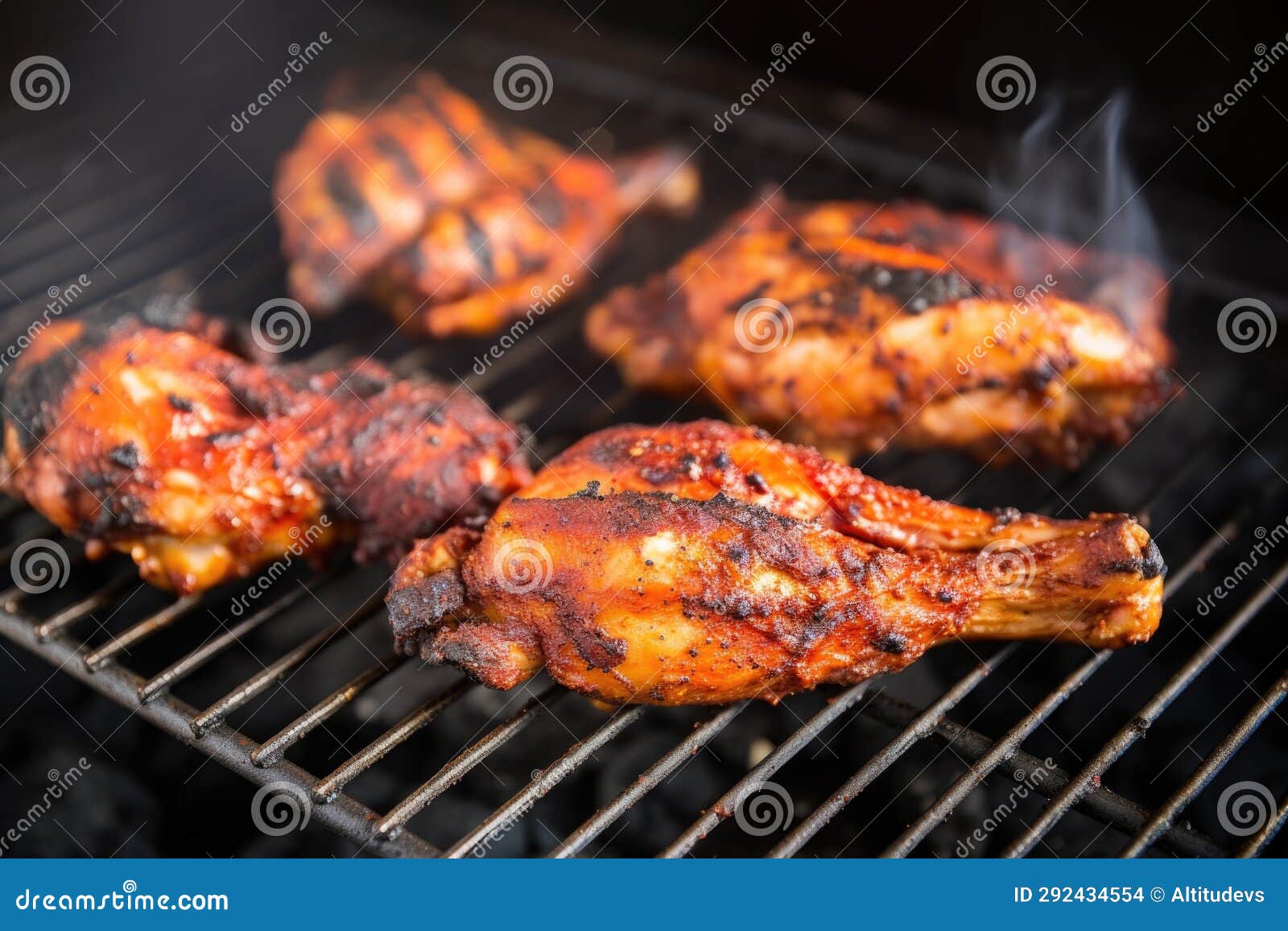 Grilled Chicken Wings with Char Marks on a Grill Rack Stock Photo