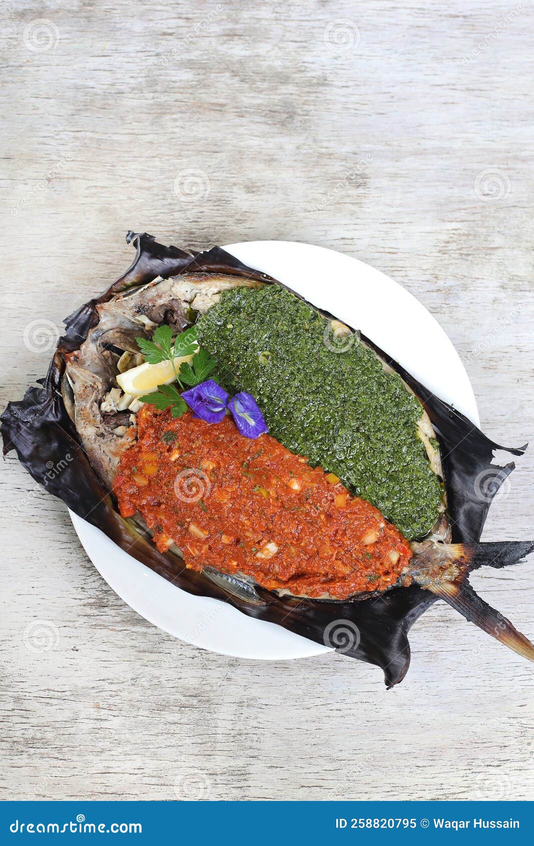 grilled chimichuri and sambal giant bangus served in a dish  on grey background side view