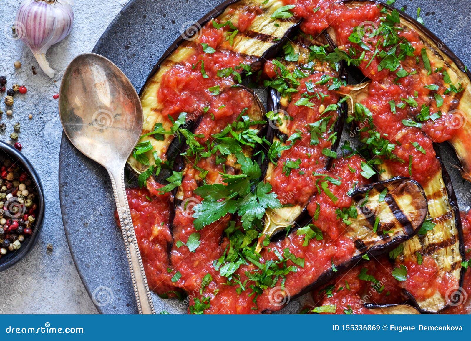 Grilled Eggplants with Tomato Sauce and Garlic in a Plate Stock Image