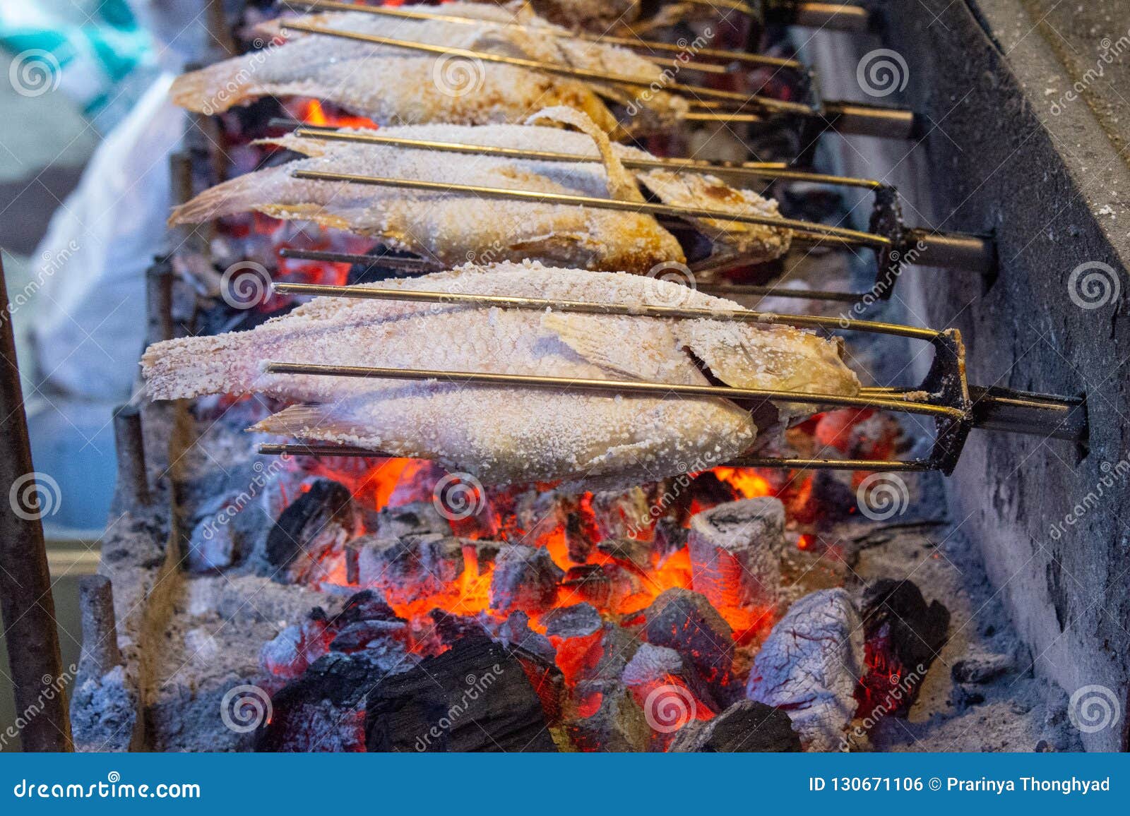Grilled fish with flames stock photo. Image of basket 130671106