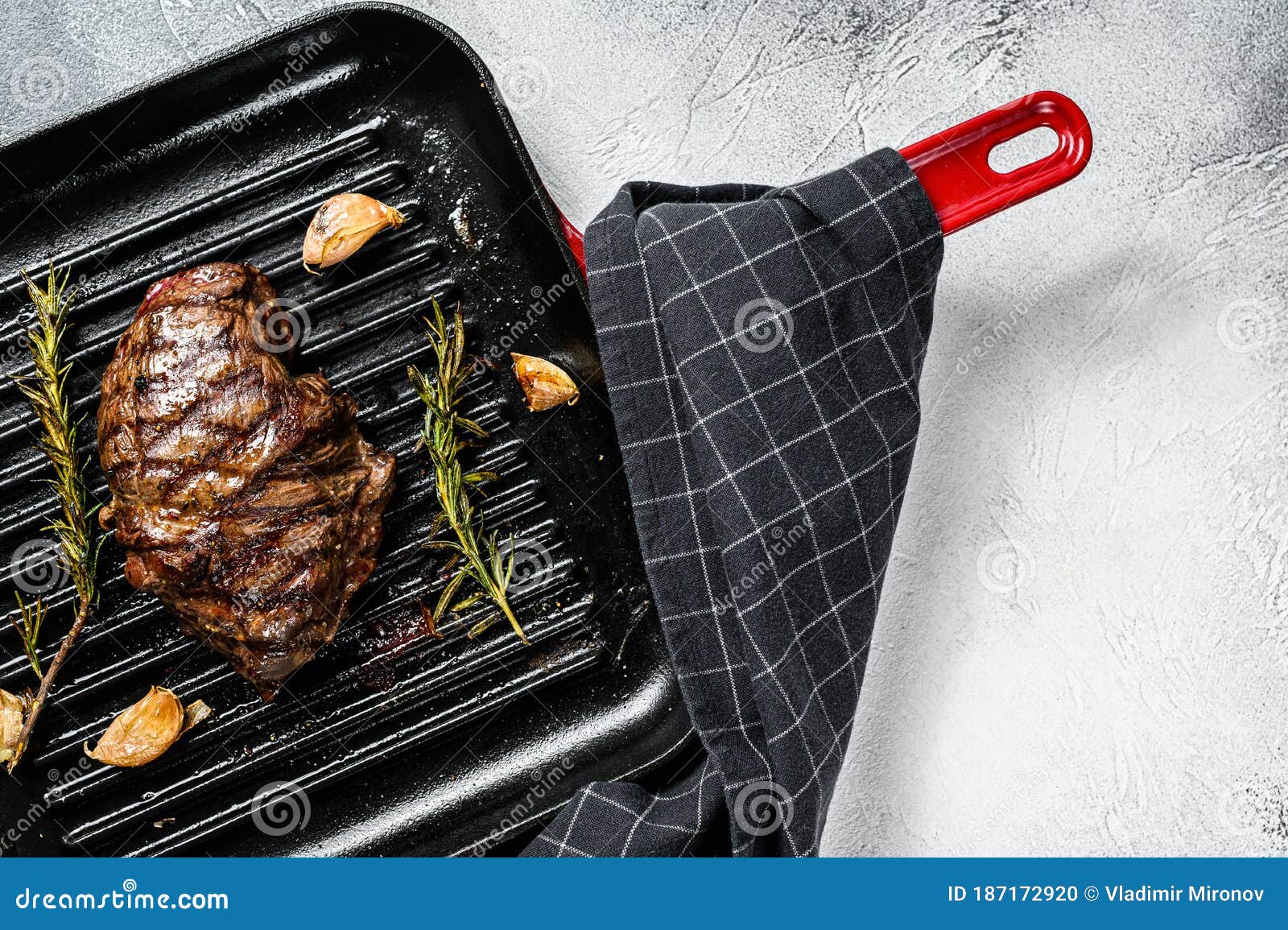 Grilled Flat Iron Steak on a Grill Pan, Marbled Beef. Gray Background
