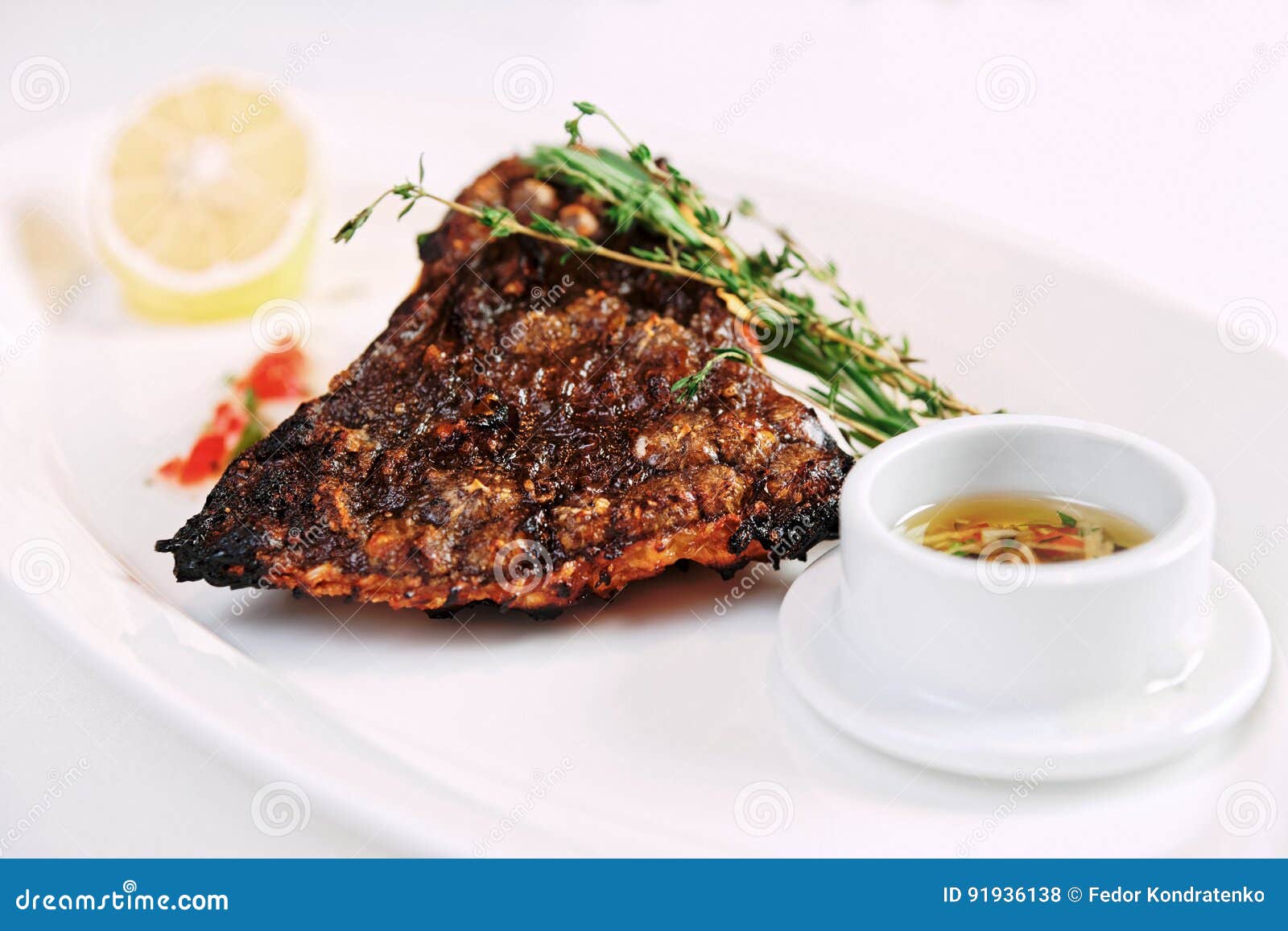 Grilled Flounder with Lemon and Savory Sauce, Toned Stock Photo Image of piece, mediterranean