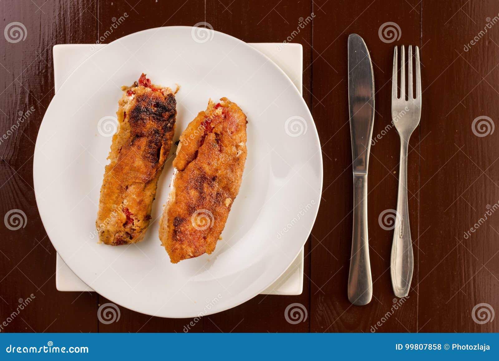 Grilled and Fried in Eggs Paprika with Knife and Fork on the Pla Stock