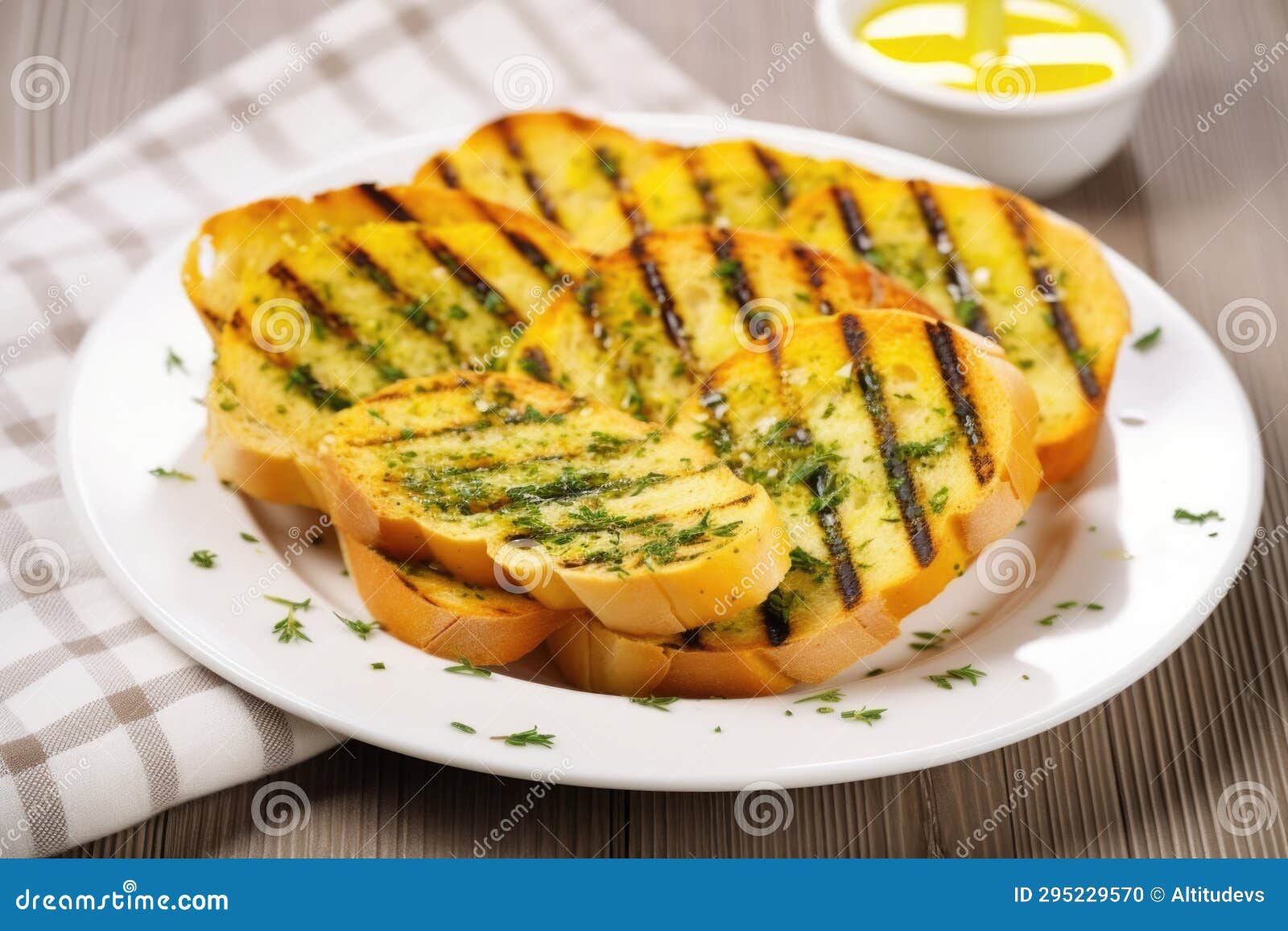 Grilled Garlic Bread Placed on a Ceramic White Plate Stock Photo