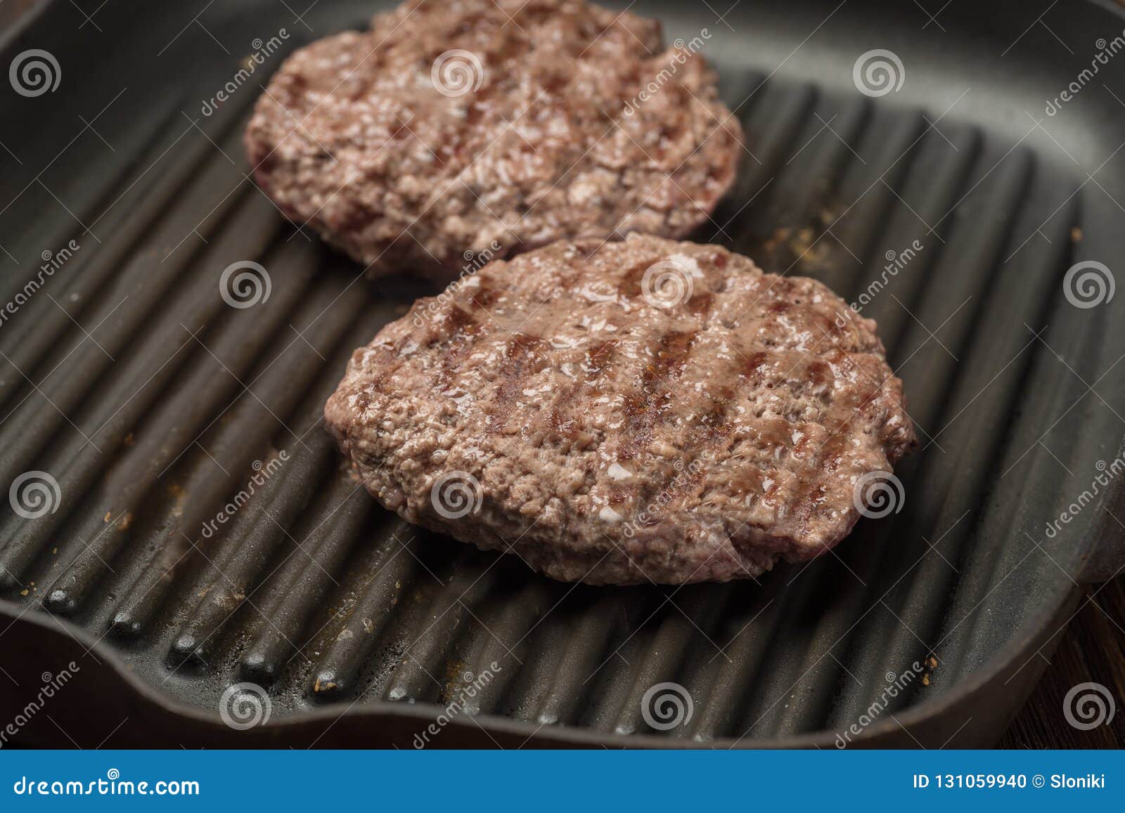 Food: Fried Homemade Burger on a Frying Pan. Stock Photo - Image of