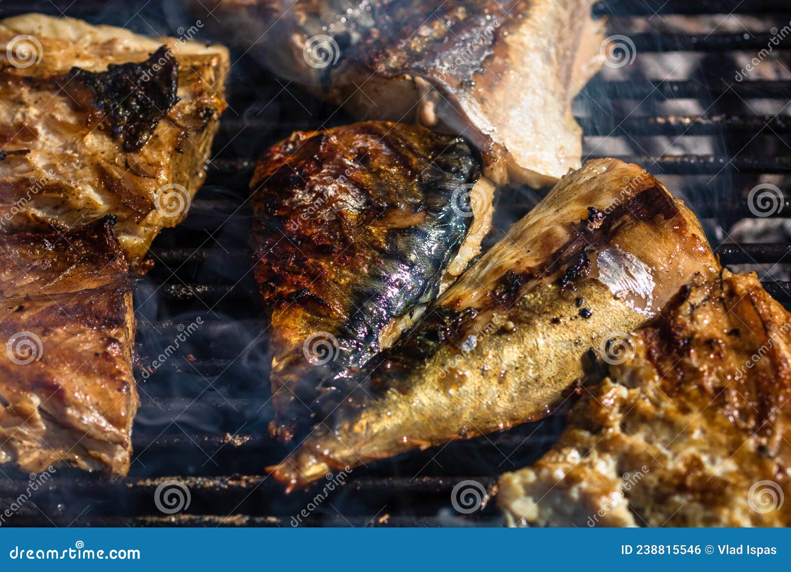 Grilled Mackerel Fish with Smoke on a Charcoal Barbecue Grill Stock