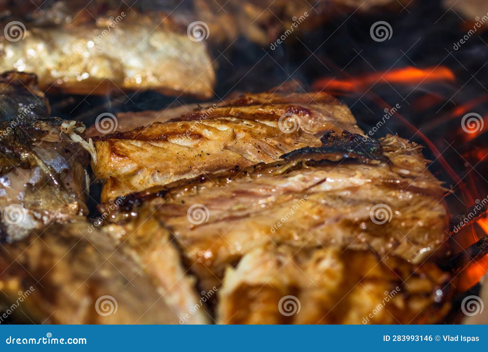 Grilled Mackerel Fish with Smoke on a Charcoal Barbecue Grill Stock