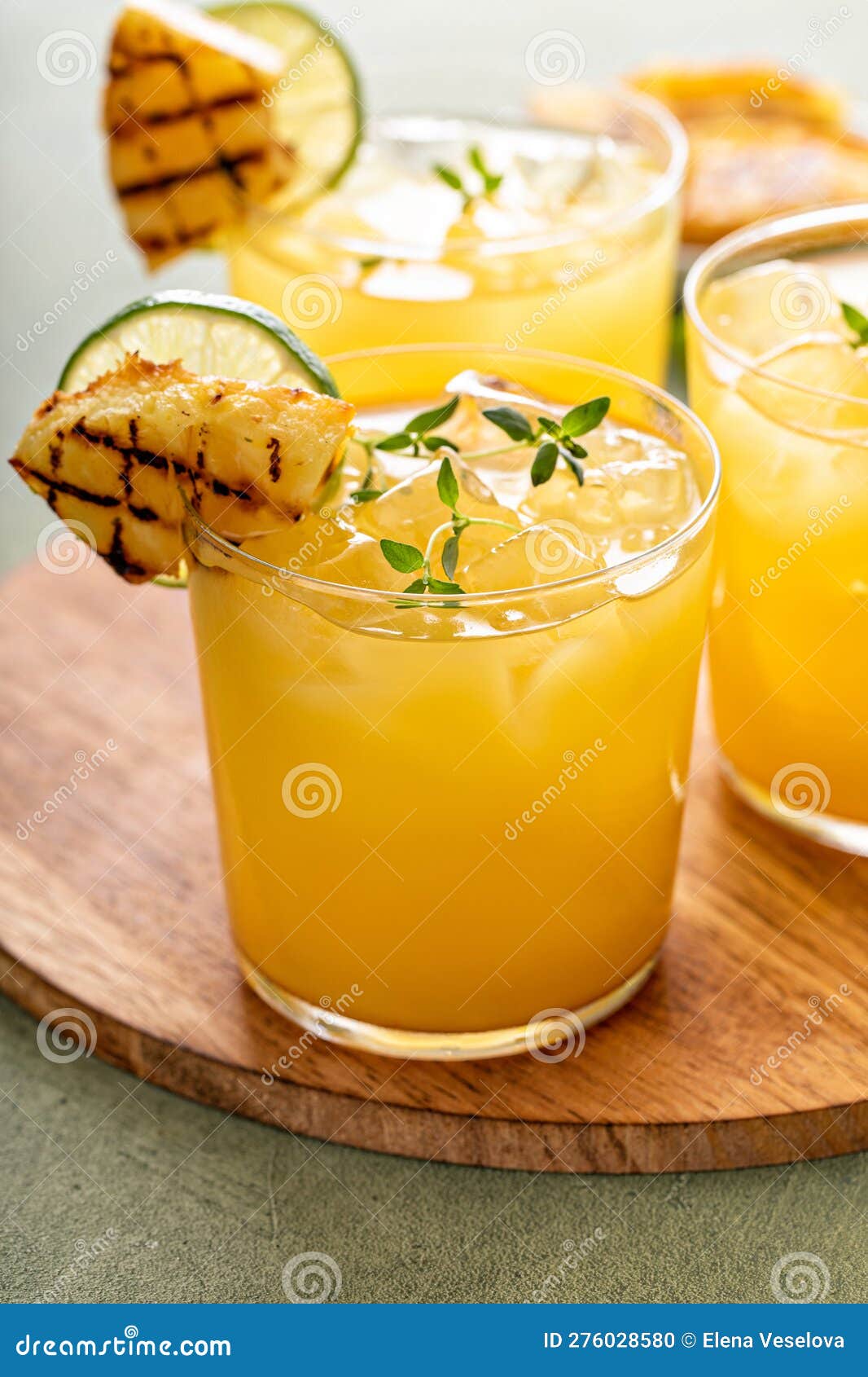 Grilled Pineapple Margarita Garnished with Lime Wedges Stock Photo