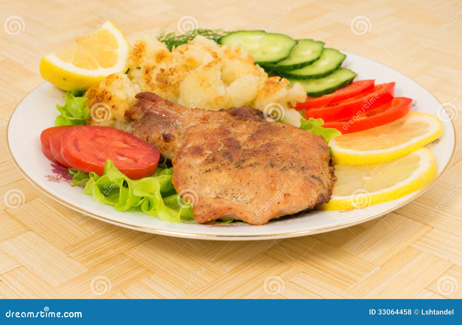 Grilled Pork Chop with a Side Dish of Cauliflower and Vegetables Stock