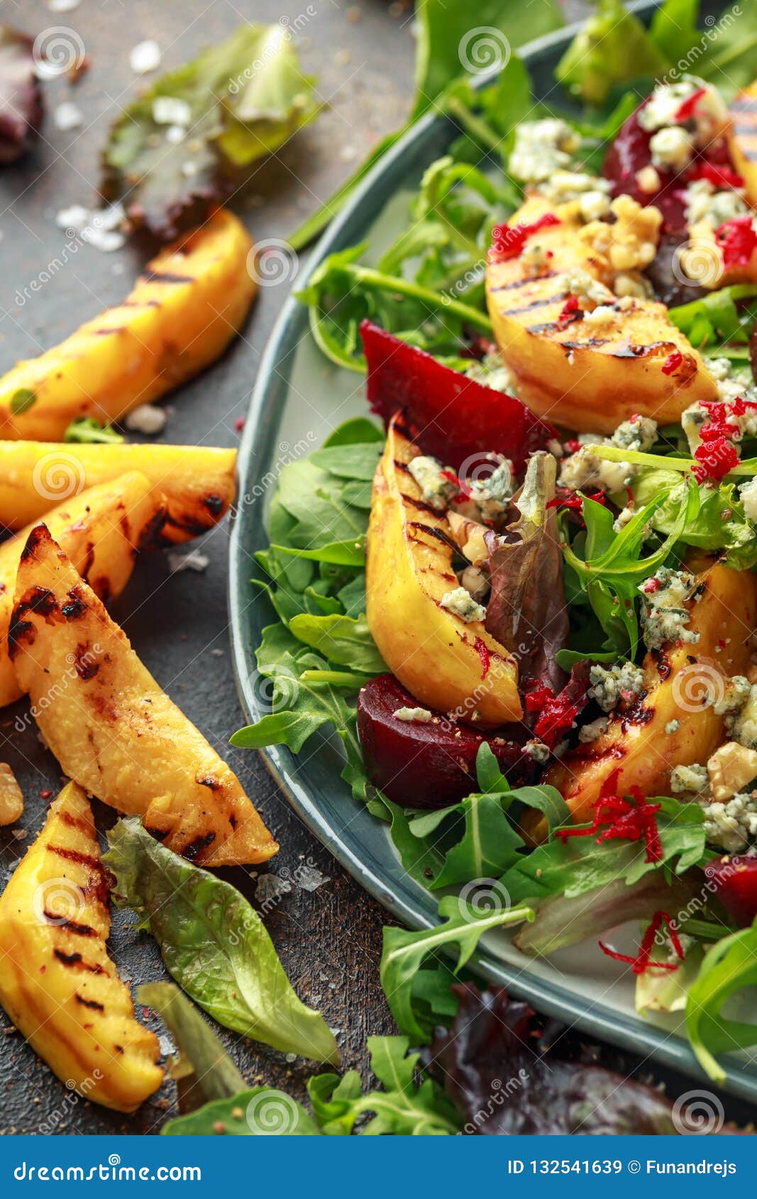 Grilled Quince Salad with Baked and Fresh Grated Beetroot, Blue Cheese, Walnuts on Rustic Table