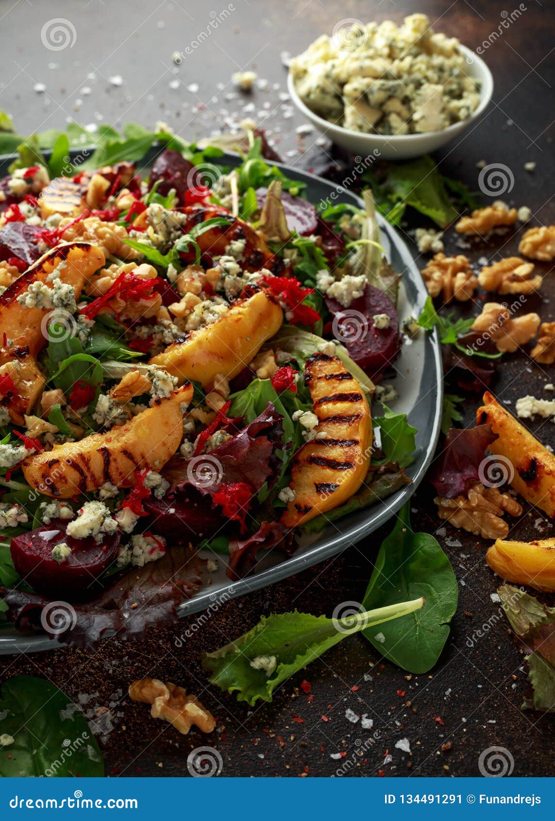 Grilled Quince Salad with Baked and Fresh Grated Beetroot, Blue Cheese, Walnuts on Rustic Table