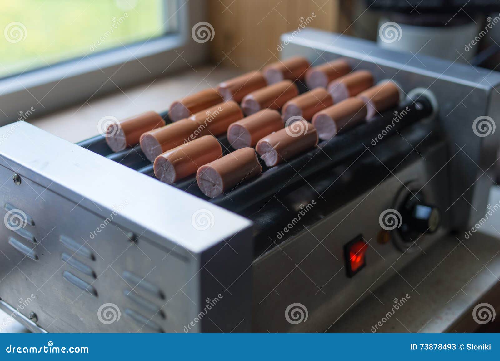 The Grilled Sausages Roll on Heating Machine. Stock Image Image of