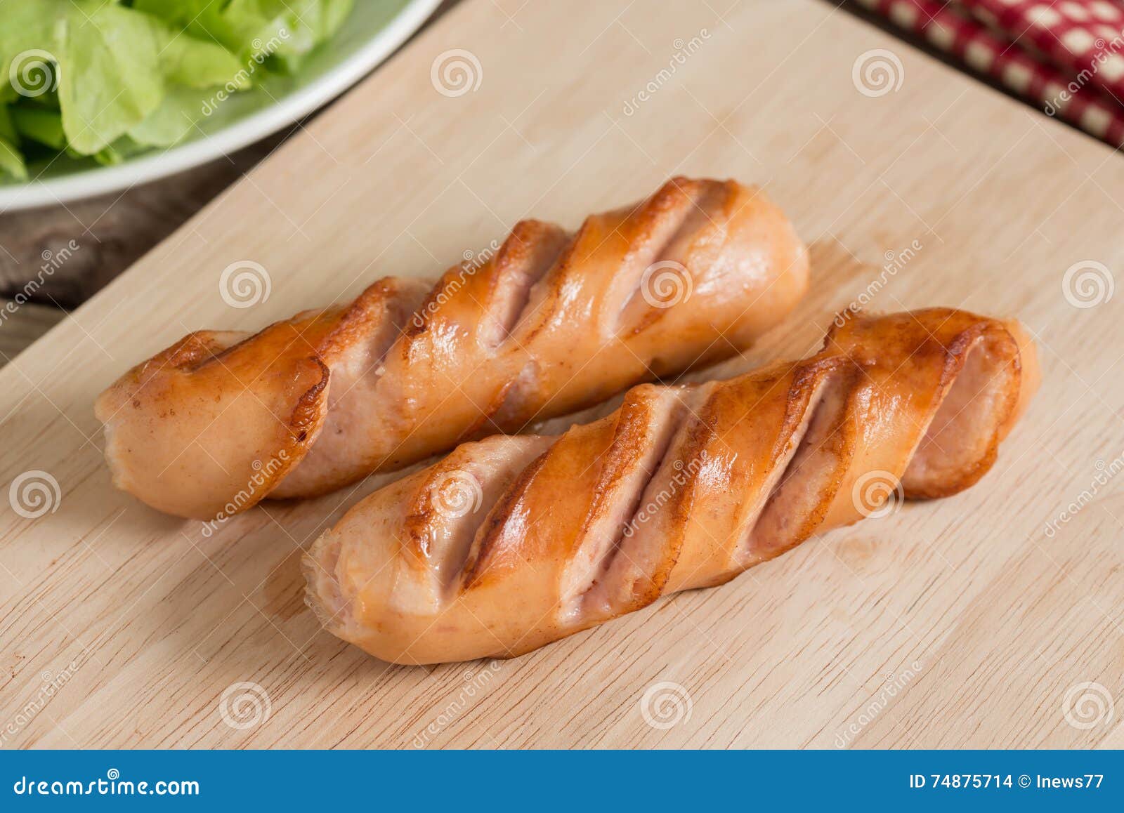 Grilled sausages on wood board.