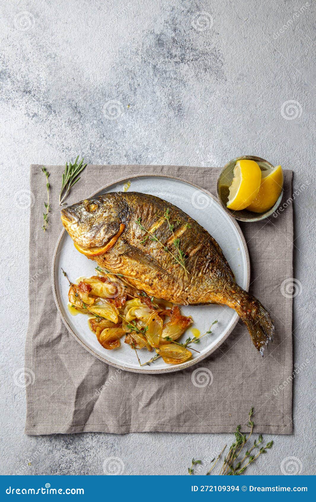 grilled sea bream or dorada on gray plate. gray background