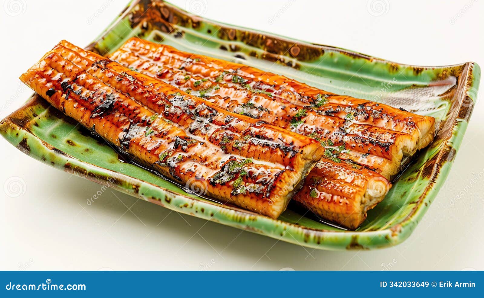 grilled unagi or eel on green plate. white background