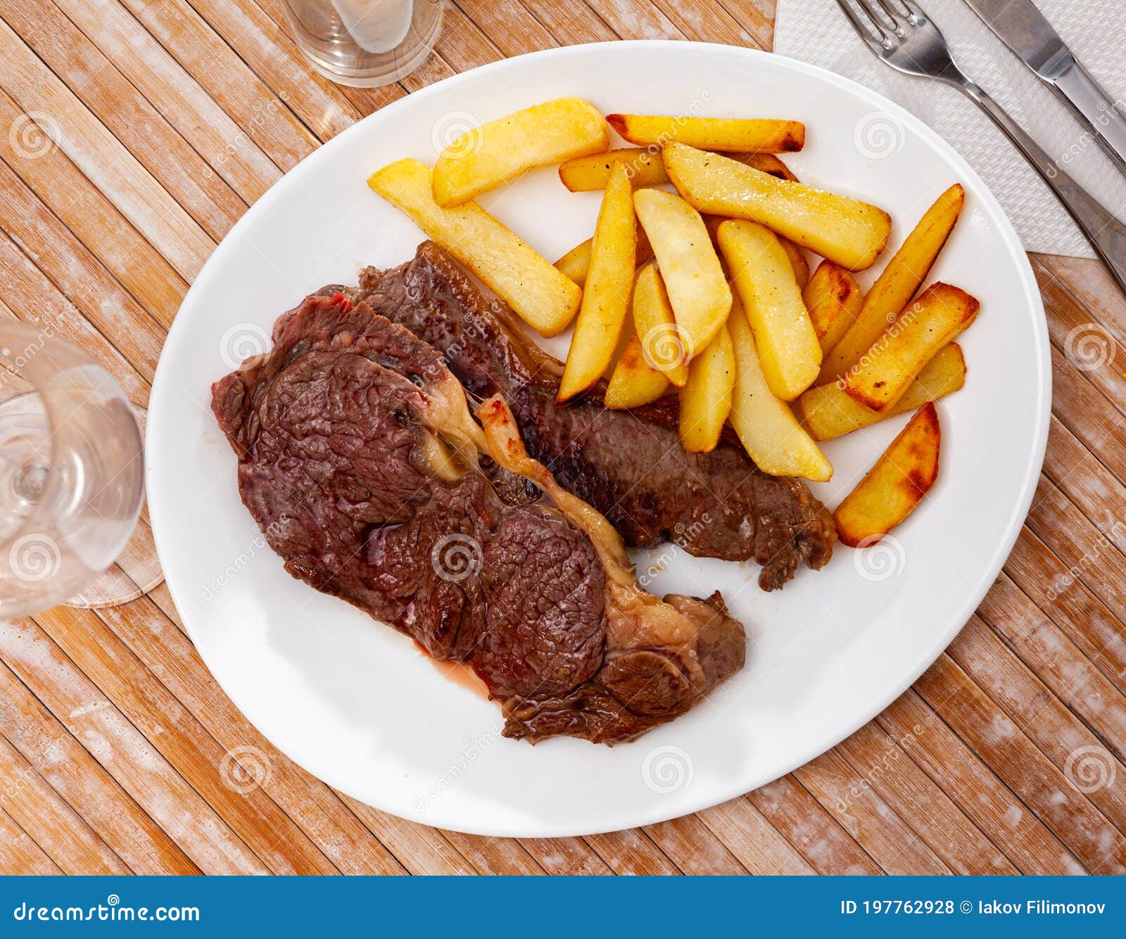 Grilled Veal Steak with Side Dish of Baked Potato Stock Photo Image