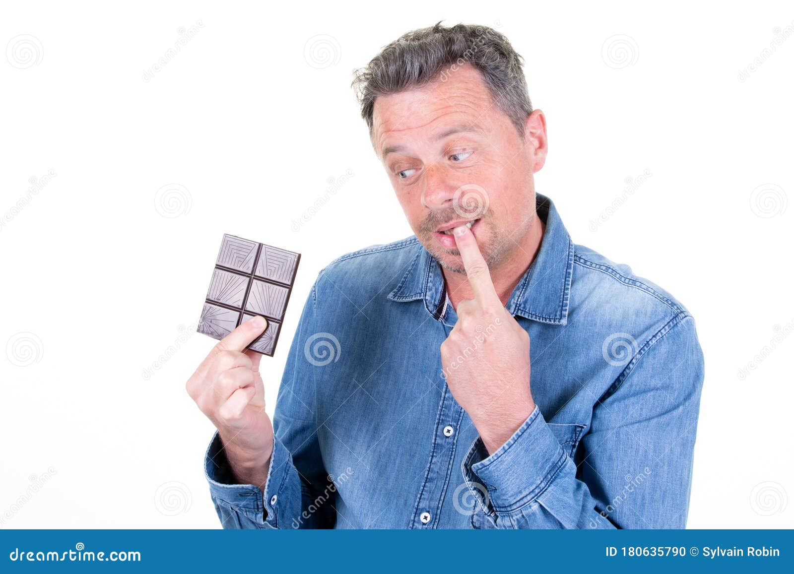 Grimace Attractive Man Thinking Eating a Chocolate Bar Finger on Mouth ...