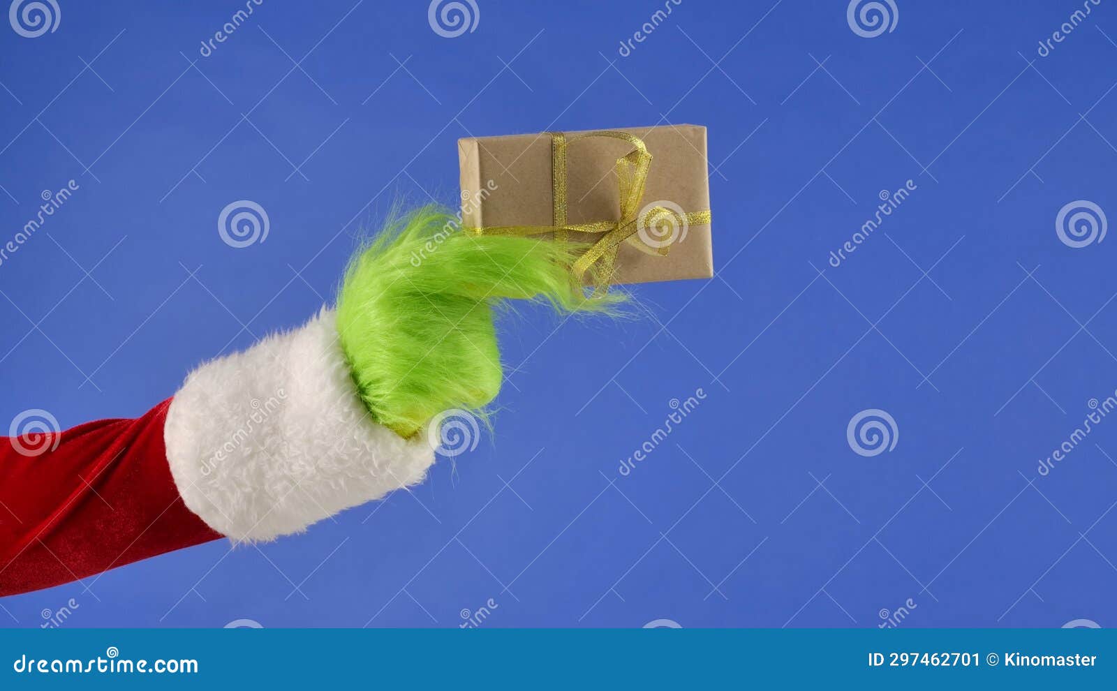 the grinch's green haired hand holds a white gift box with a gold bow on an  blue background. gift kidnapper