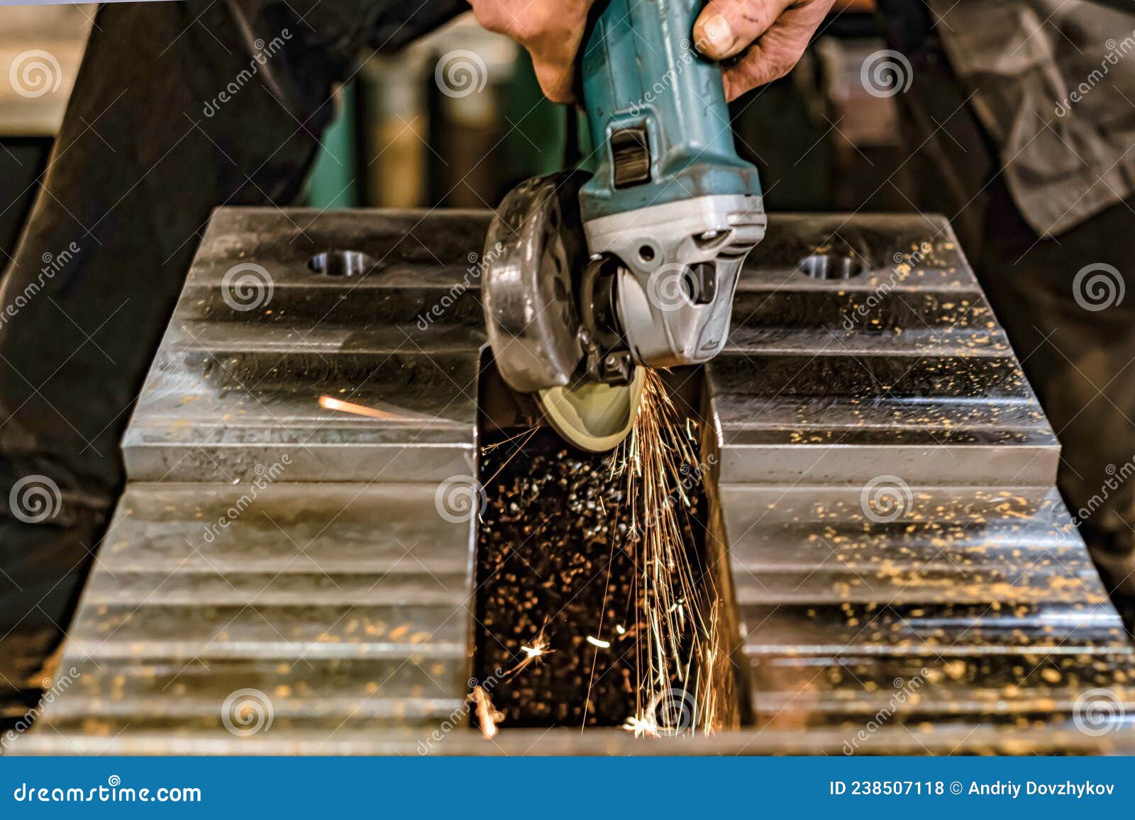 Grinding Burrs and Metal with an Angle Grinder with Sparks Stock Photo