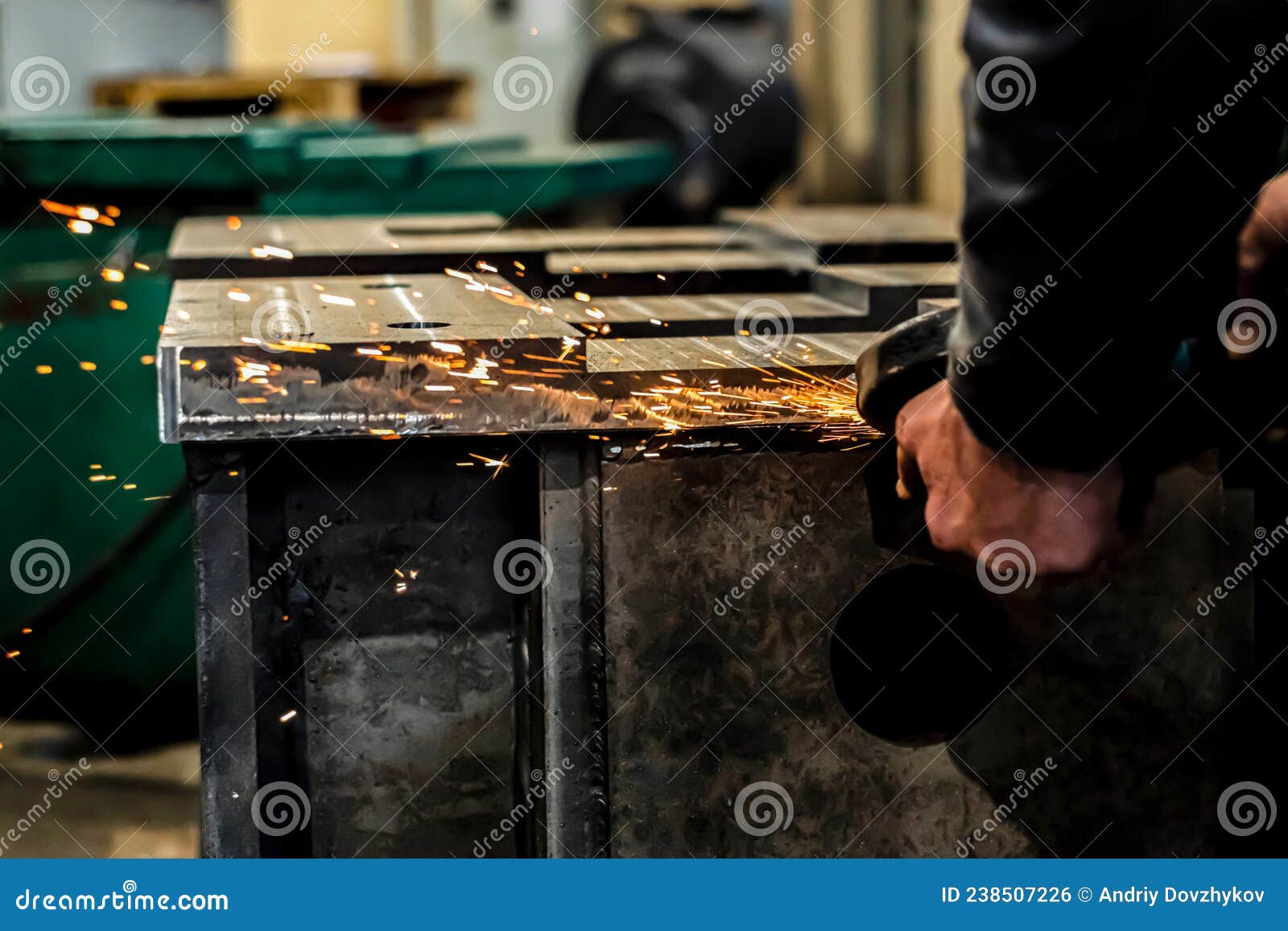 Grinding Burrs and Metal with an Angle Grinder with Sparks Stock Photo