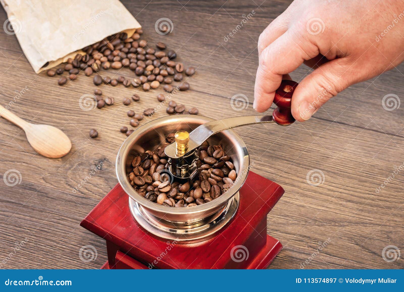 Grinding Coffee on an Old Handmade Coffee Grinder_ Stock Image Image