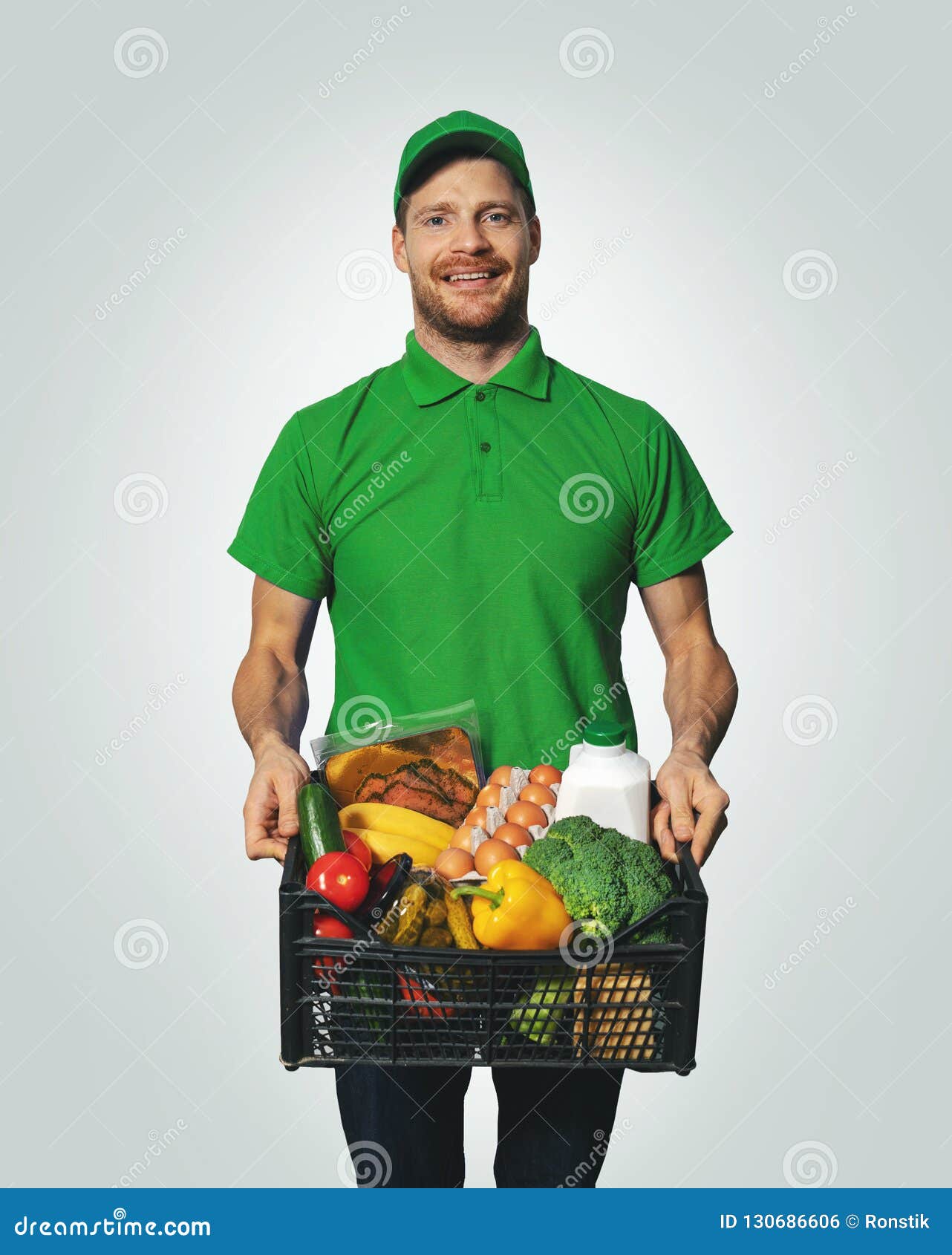 groceries delivery - man in green uniform with food box
