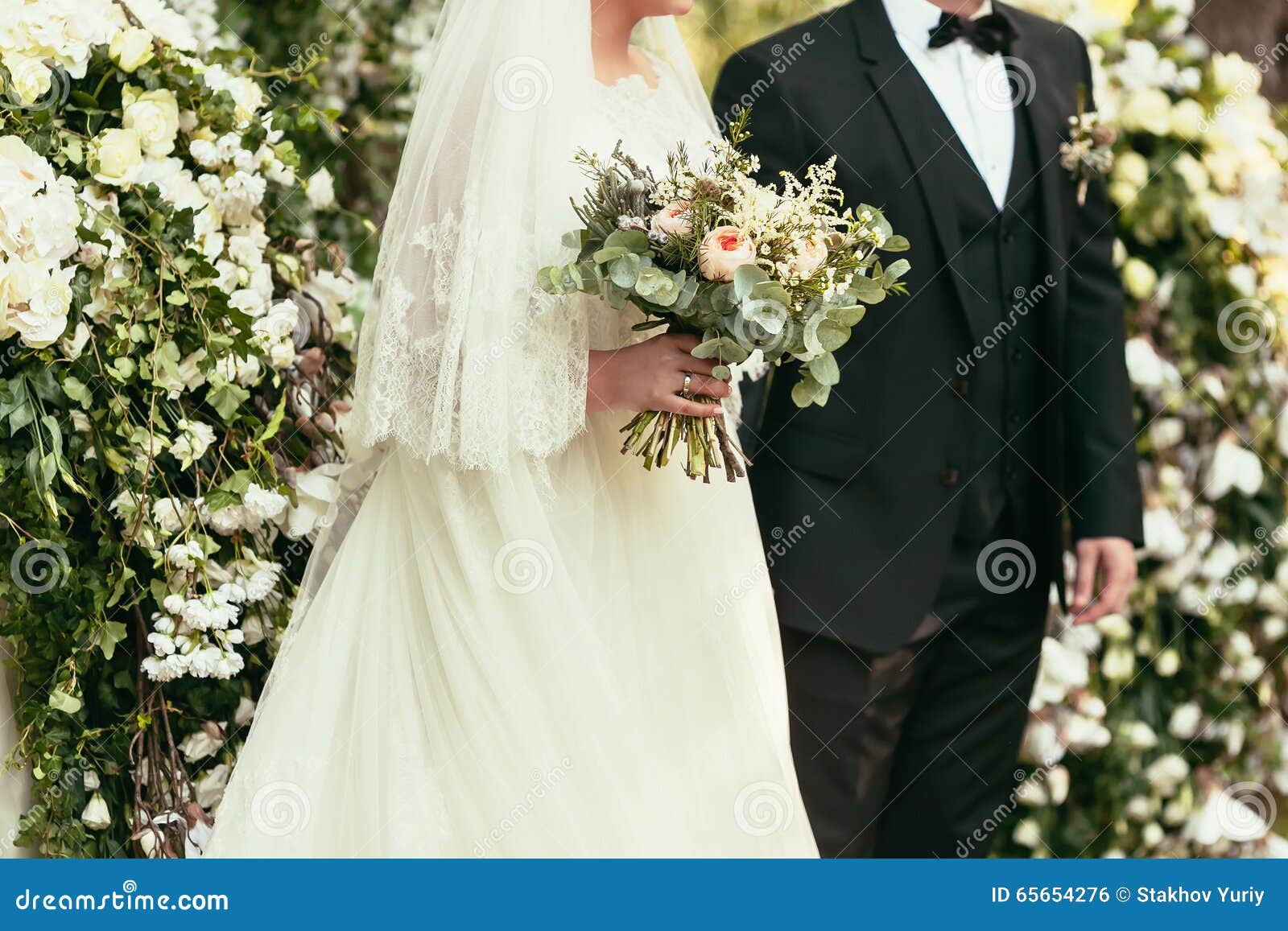 Groom In Black  Suit  And Bride In White Wedding  Dress  With 
