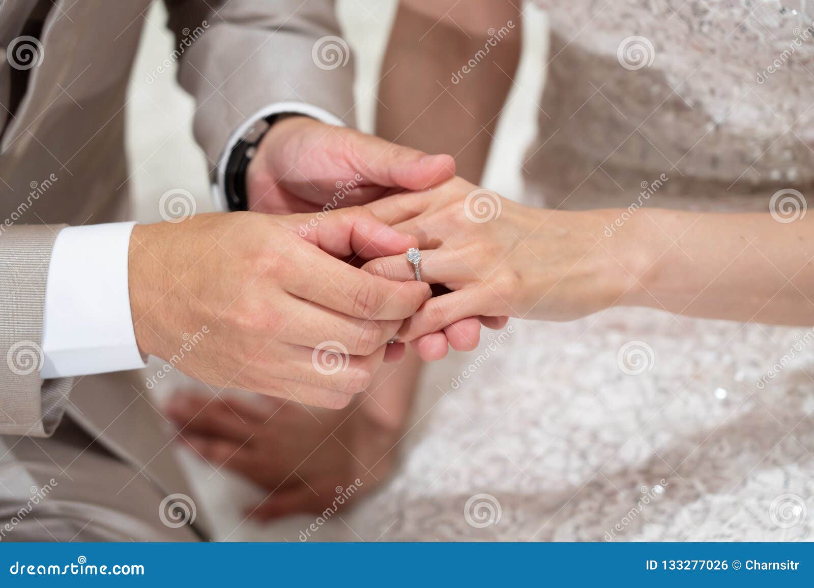 The Groom Put a Wedding Ring into a Bride Finger InThai Wedding Stock