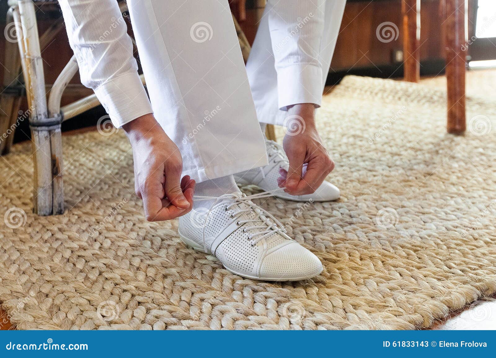 Groom Putting On White Shoes For The Beach Wedding On A
