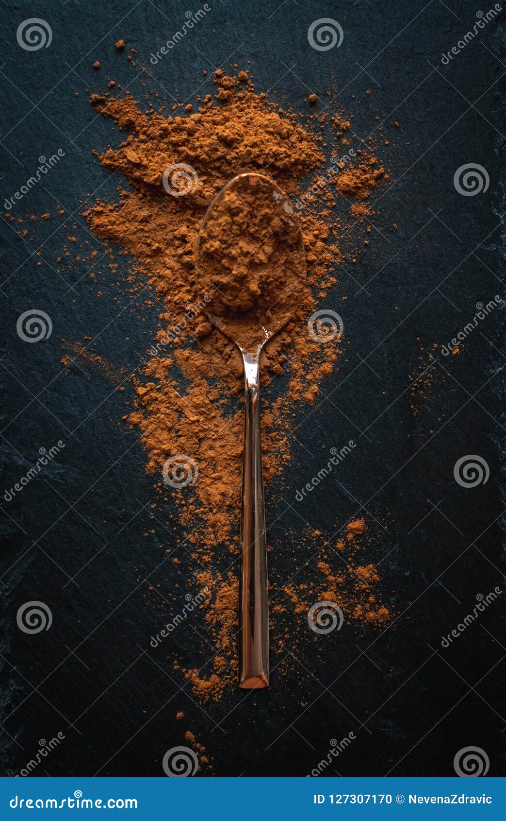 Ground Cinnamon in Teaspoon on Dark Background, Top View, Text Space