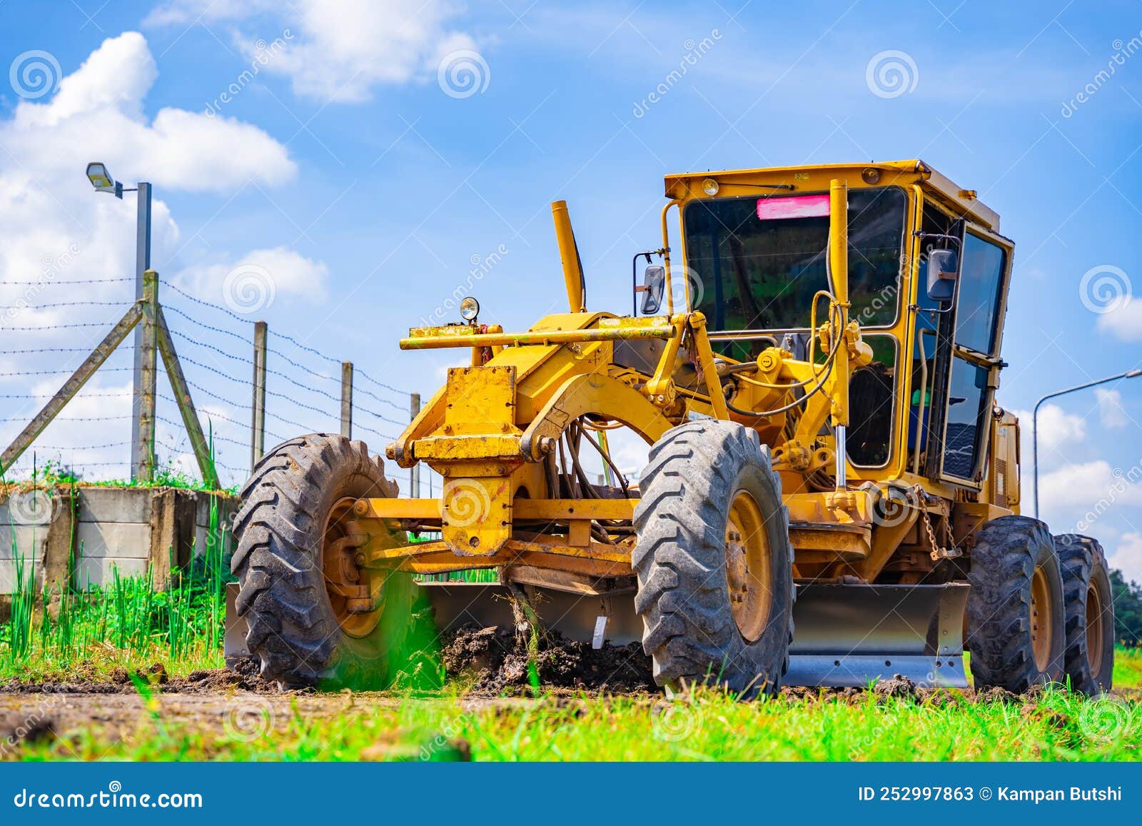 the ground grader is adjusting the road surface evenly to the level that engineers have calculated, industrial road construction,