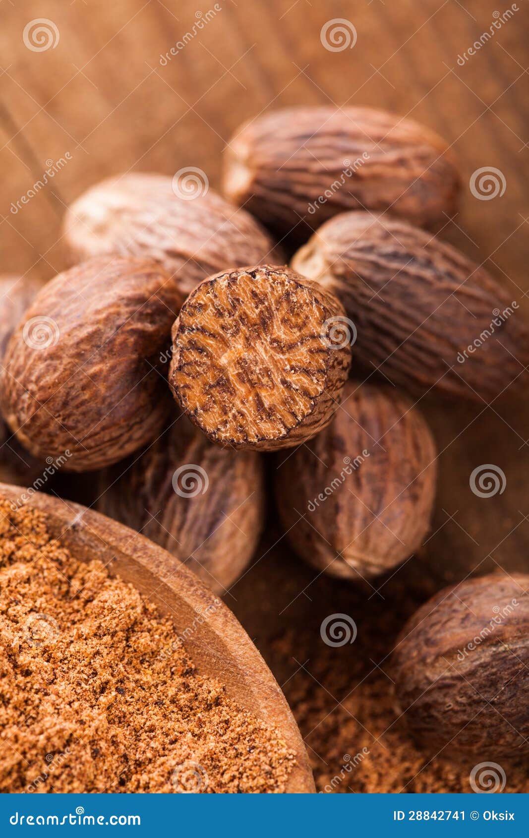 Ground Nutmeg Powder Spice In Wooden Bowl, Isolated On White Background