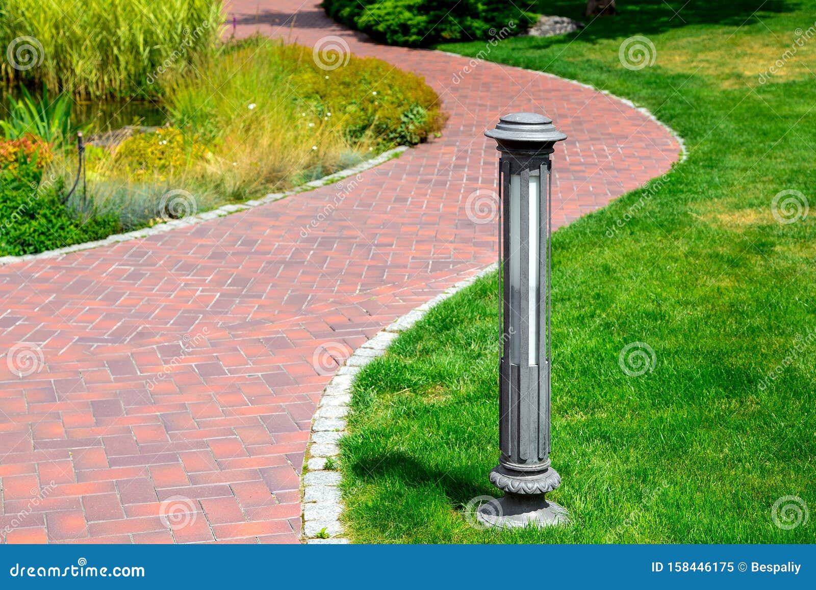 Ground Street Lamp Mounted on a Green Lawn in a Park. Stock Image