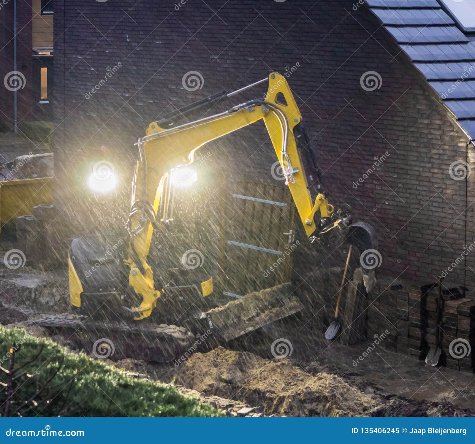 Ground Worker Working at Night in Bad Rainy Weather, Constructing a