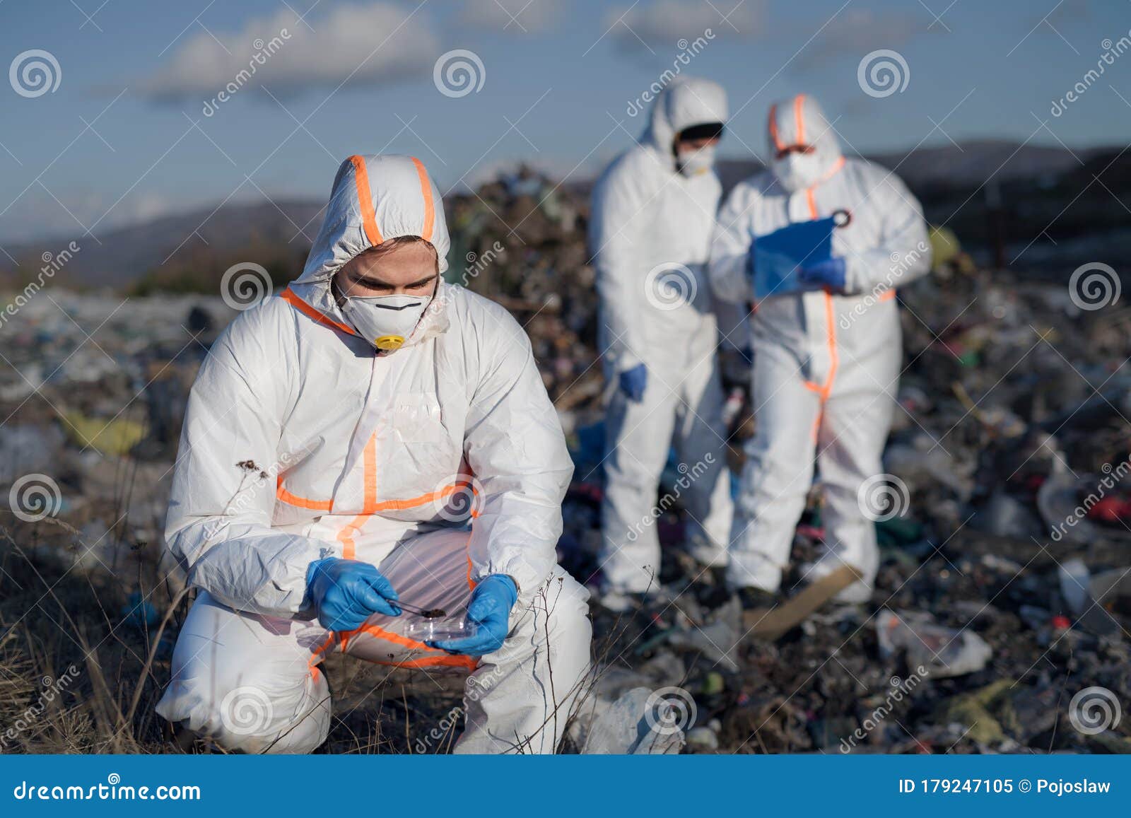 Group of Activists with Protective Masks on Landfill, Environmental Pollution Concept. Stock