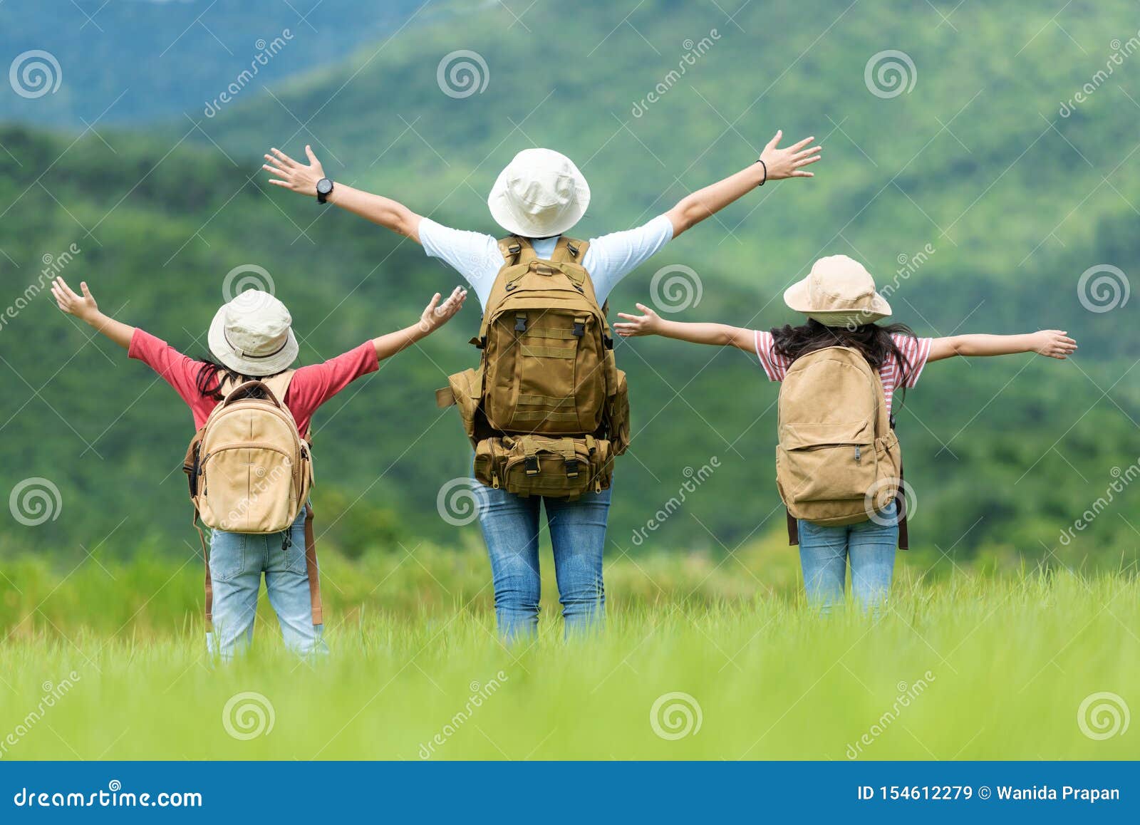 group asian family children raise arms and standing see the outdoors, adventure and tourism for destination and leisure trips with