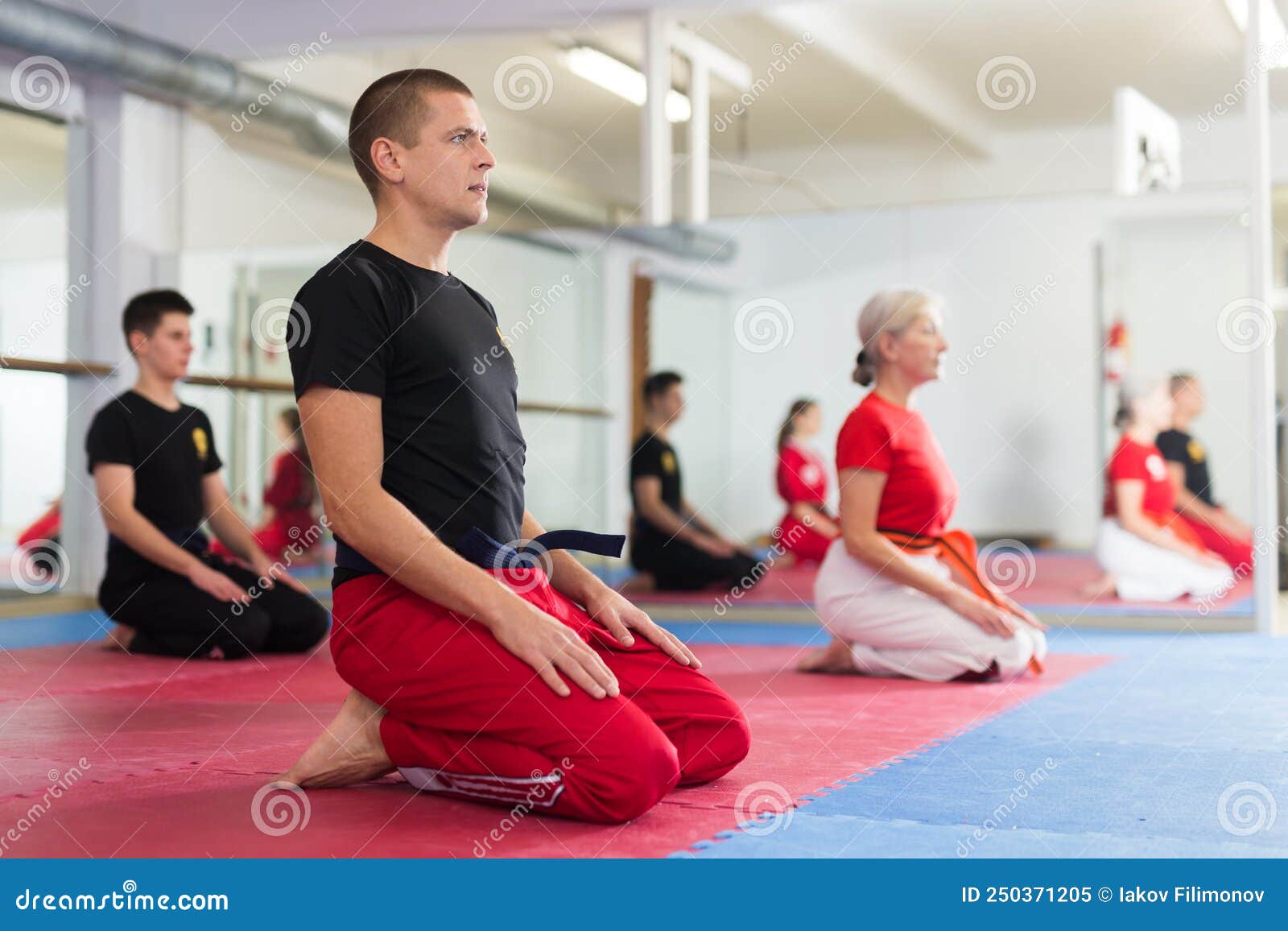Group Of Athletes Cheering Karate Coach Before Training Stock Image