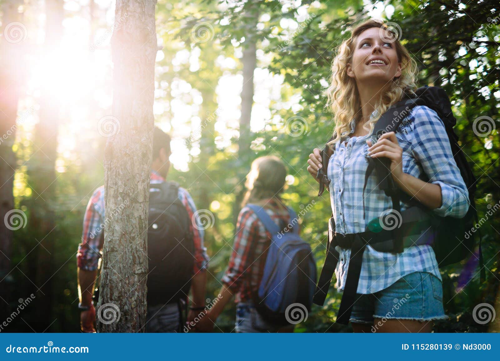 Group of Backpacking Hikers Going for Forest Trekking Stock Image