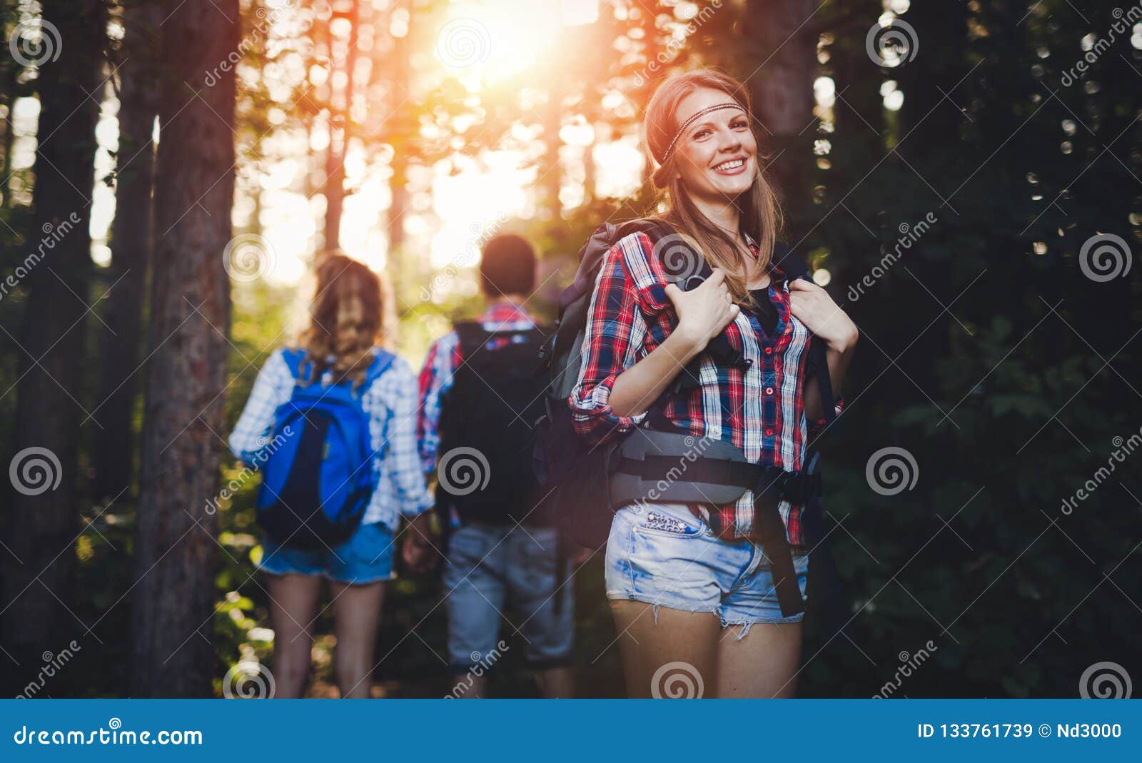 Group of Backpacking Hikers Going for Forest Trekking Stock Image