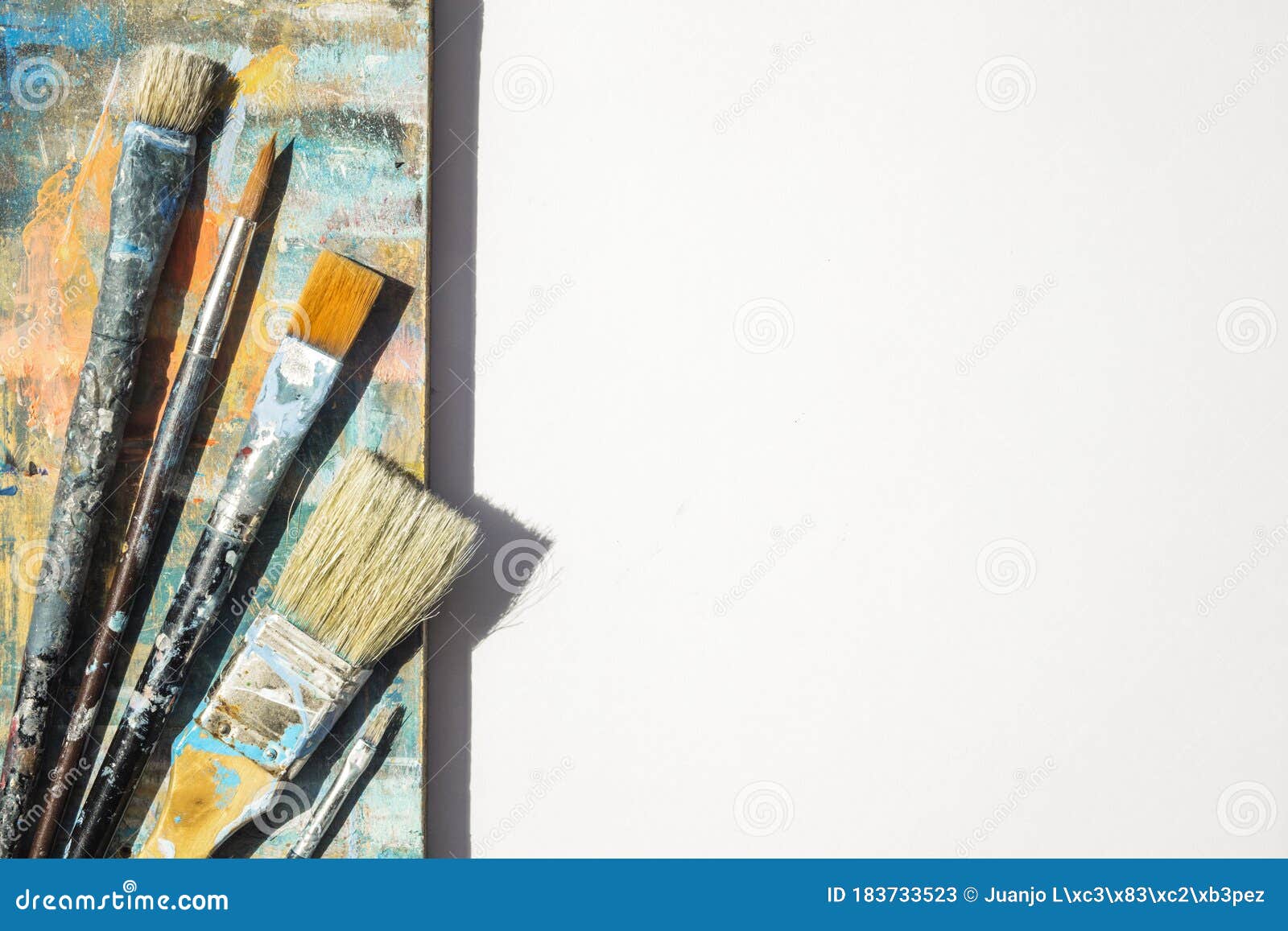 Group of Brushes and Spatula on a Colorful Background and White